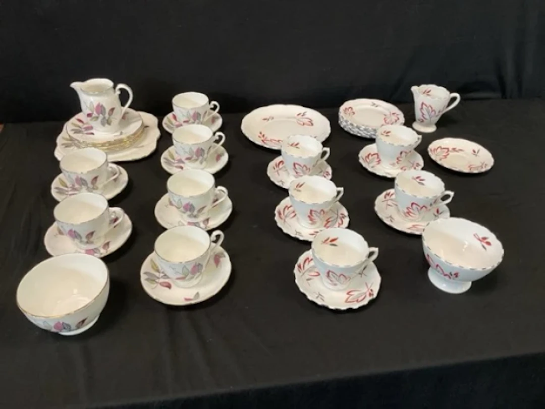 A Phoenix Bone China tea service handpainted with stylised leaves;