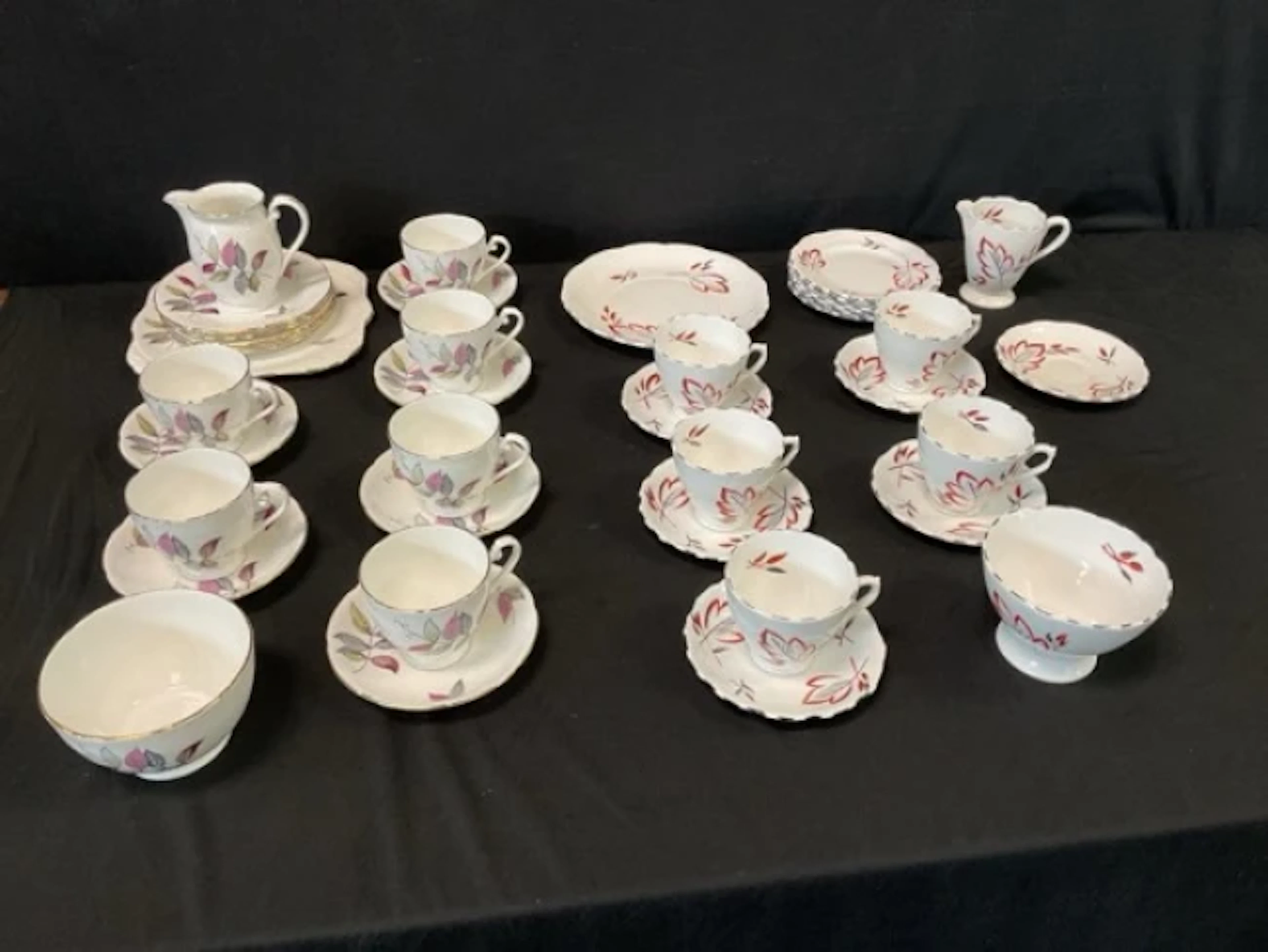 A Phoenix Bone China tea service handpainted with stylised leaves;
