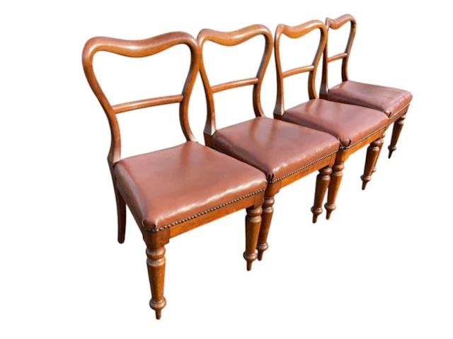 A set of four Victorian mahogany balloon-back style chairs with brass