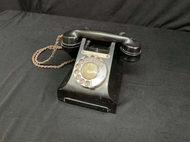 A 50s GPO 332L black bakelite rotary telephone, the receiver with