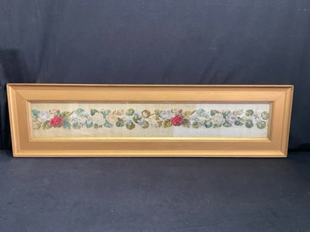 A Victorian long woolwork tapestry panel of a garland of roses and