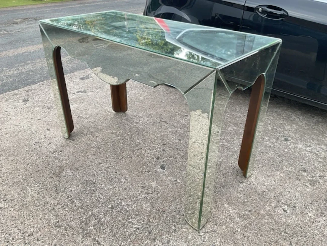 A contemporary mirrored centre table with bevelled glass and shaped