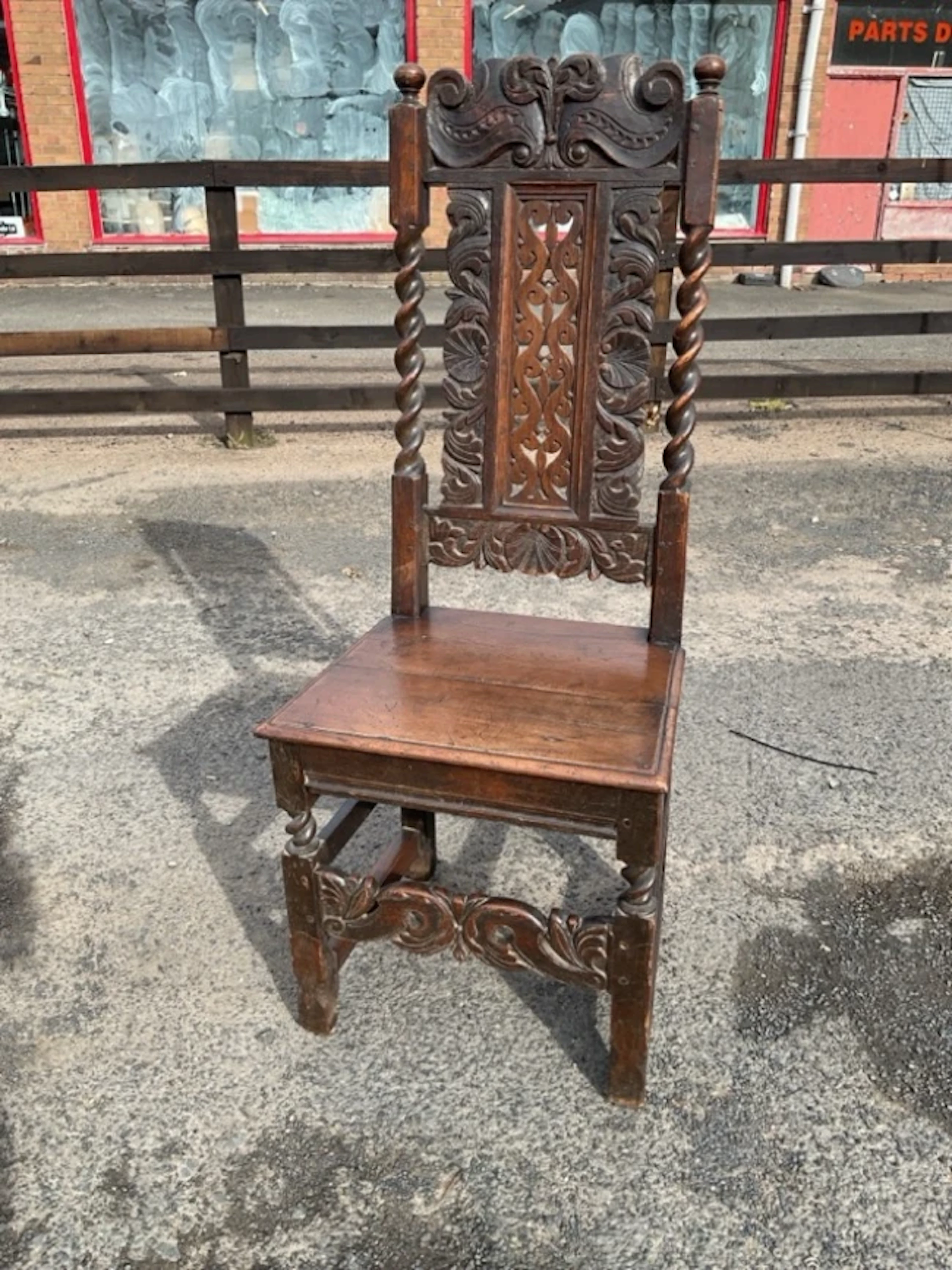 A Victorian carved oak side chair with foliage scroll carved back