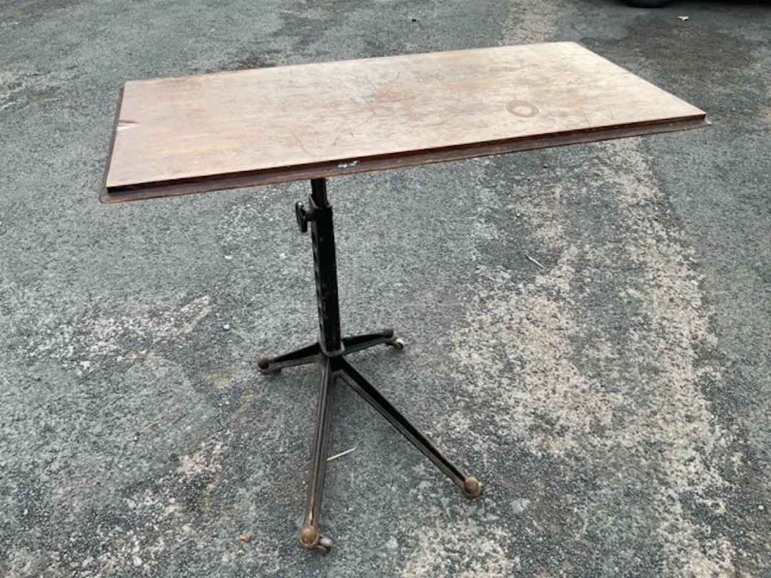 An Edwardian adjustable cast iron table, with rectangular top on stand