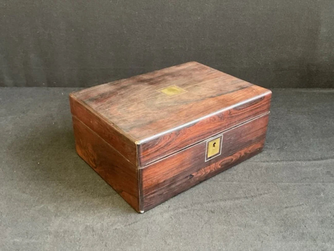 A Victorian rosewood box with internal tray, having rectangular brass