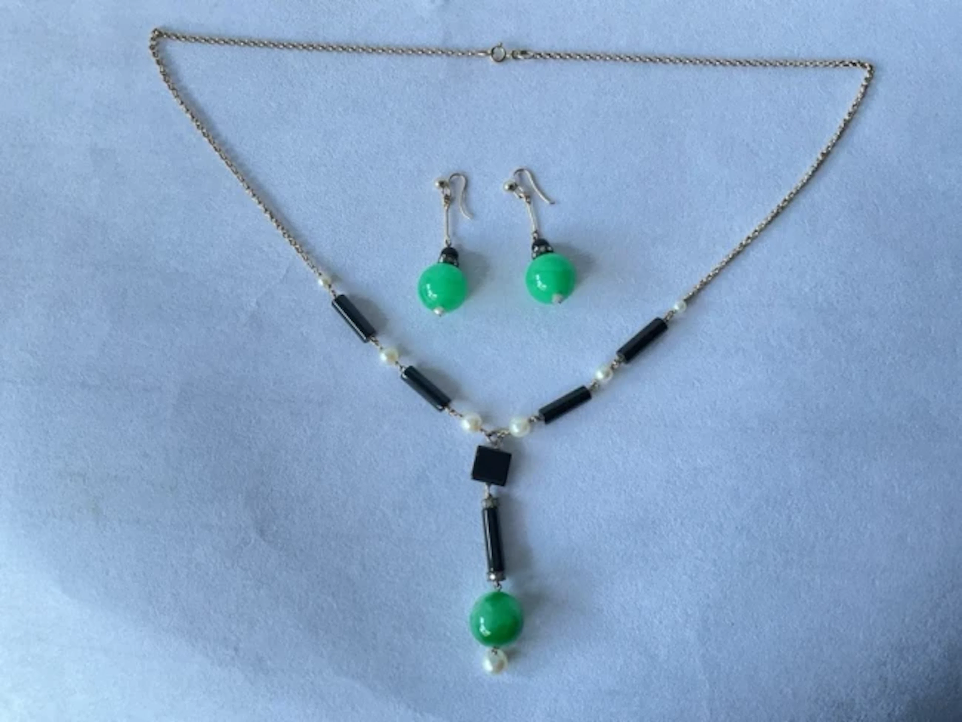 A 9ct gold deco jade, pear & diamond necklace and earring set, having