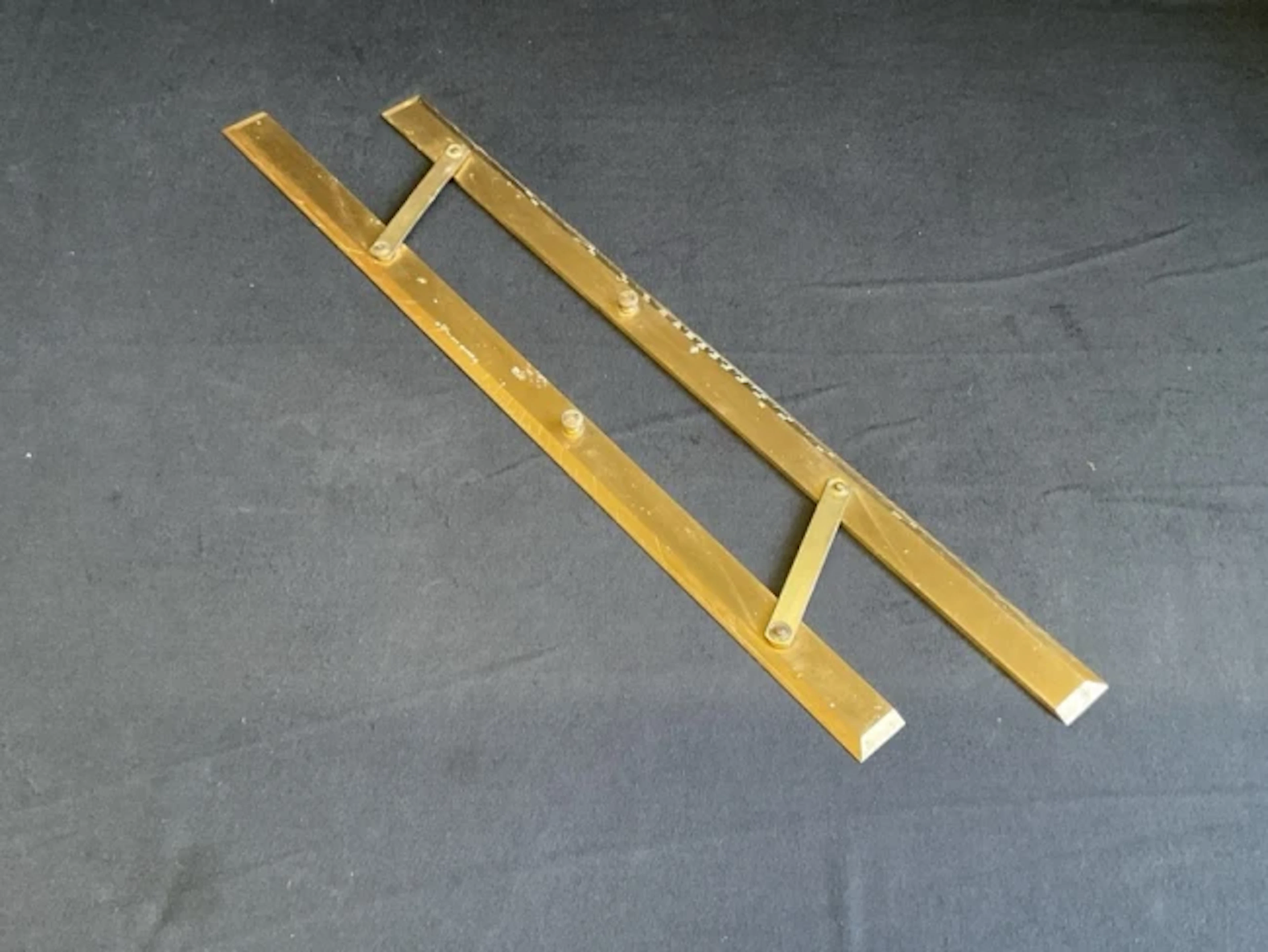 A lacquered brass navigational ruler with two bevelled hinged sections