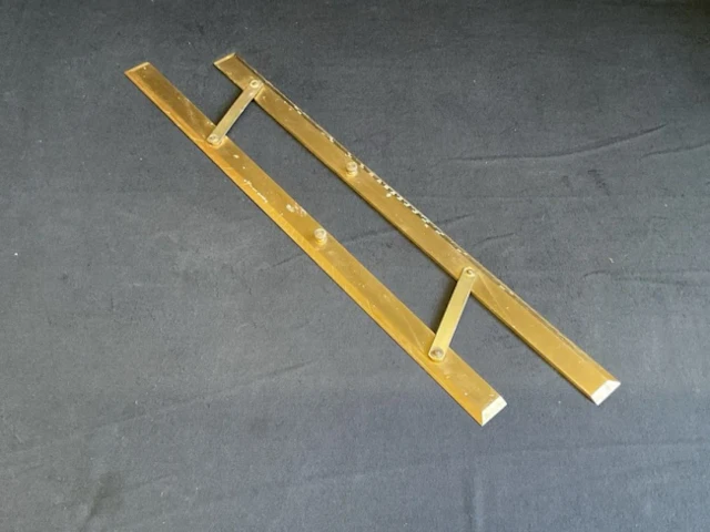 A brass navigational ruler with two bevelled hinged sections calibrated