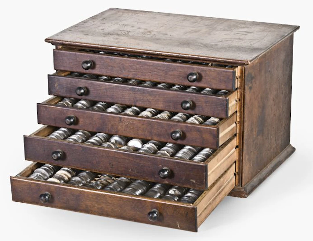 A good late 19th - early 20th century five drawer crystal cabinet with contents