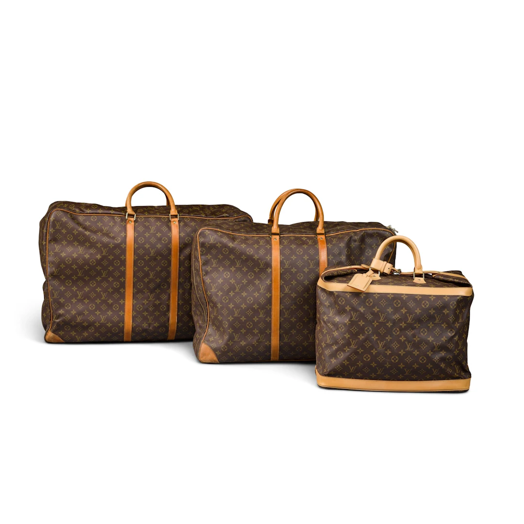 A group of vintage Louis Vuitton canvas and leather bags, modern