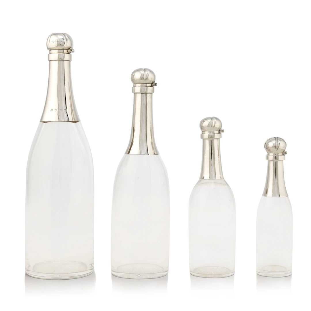 A group of Victorian silver champagne decanters, the largest Hukin