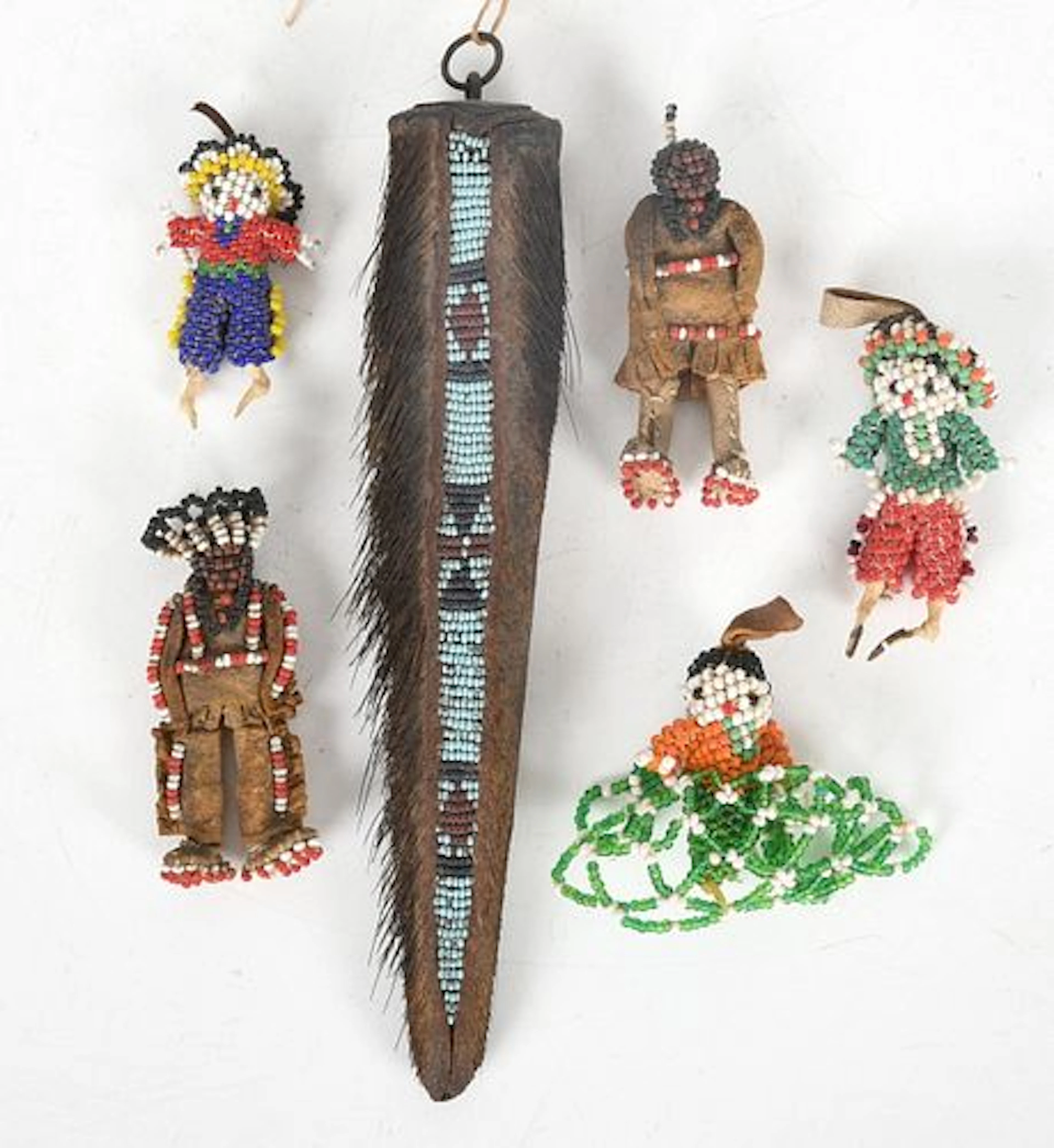 A Native American Beaded Bear Tail Charm and Five Beaded Figures
