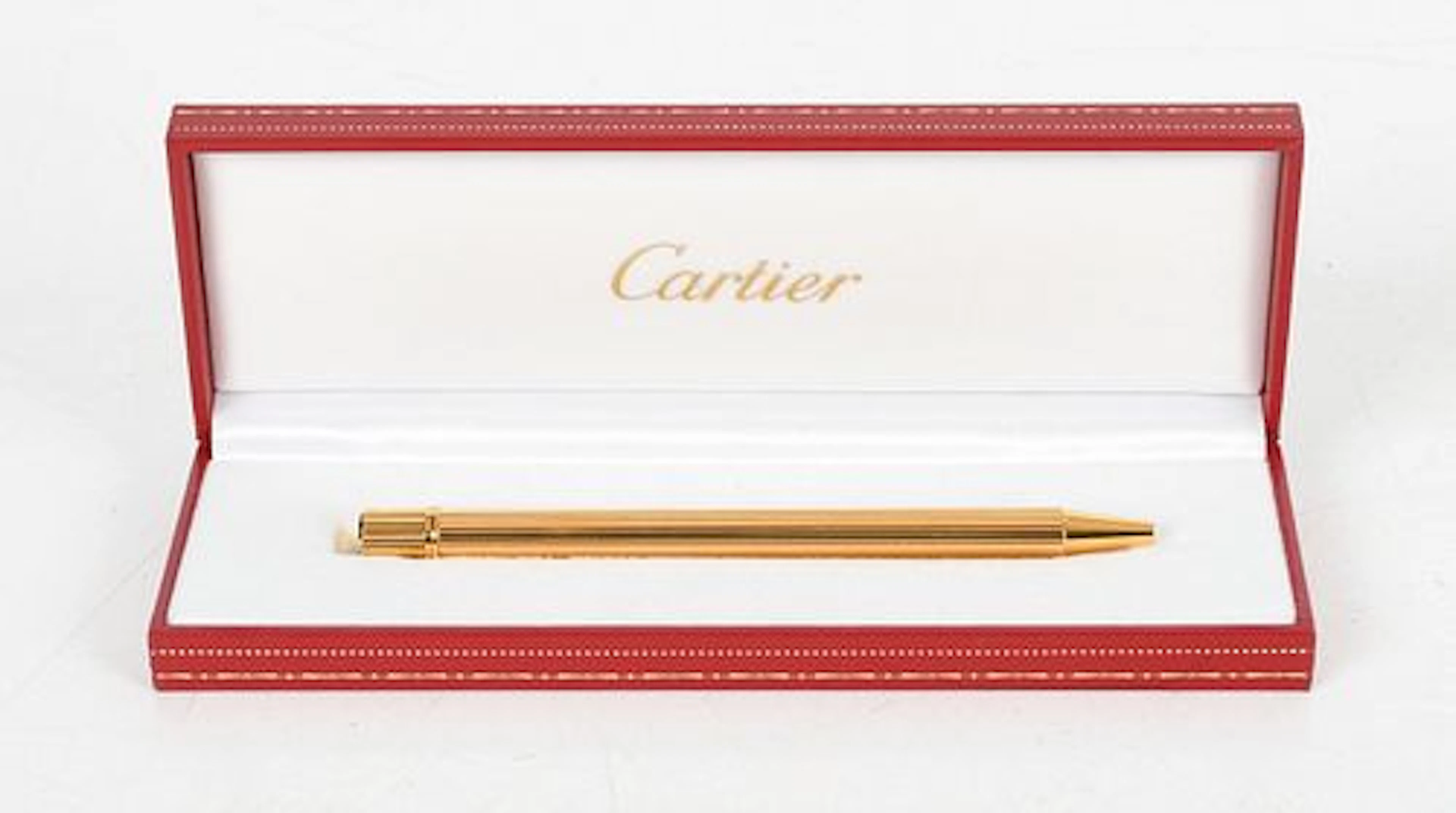 A Cartier Gold Plated Must de Cartier Ballpoint Pen and Box