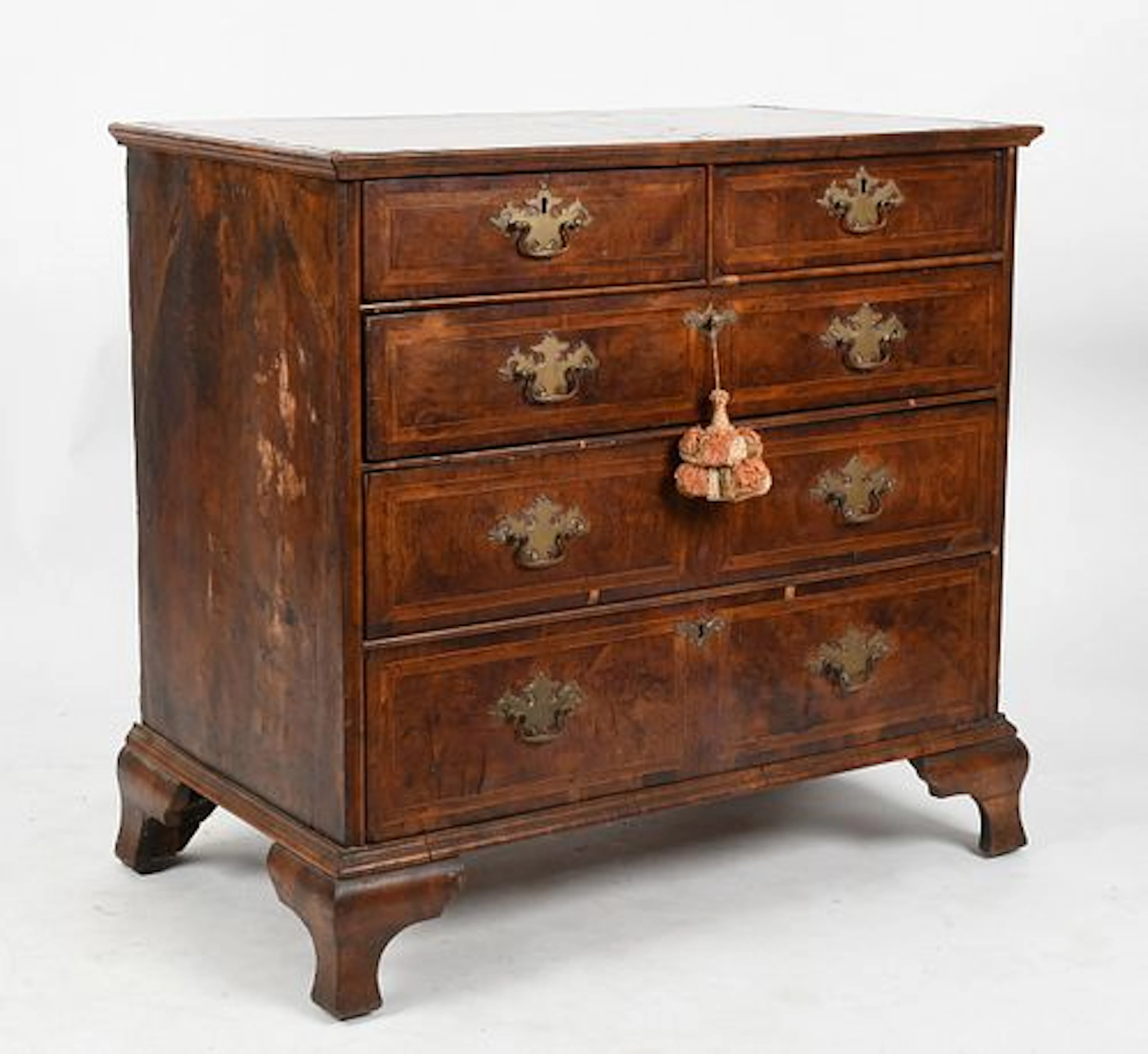 A George II Cross-Banded Walnut Chest of Drawers, Mid 18th Century