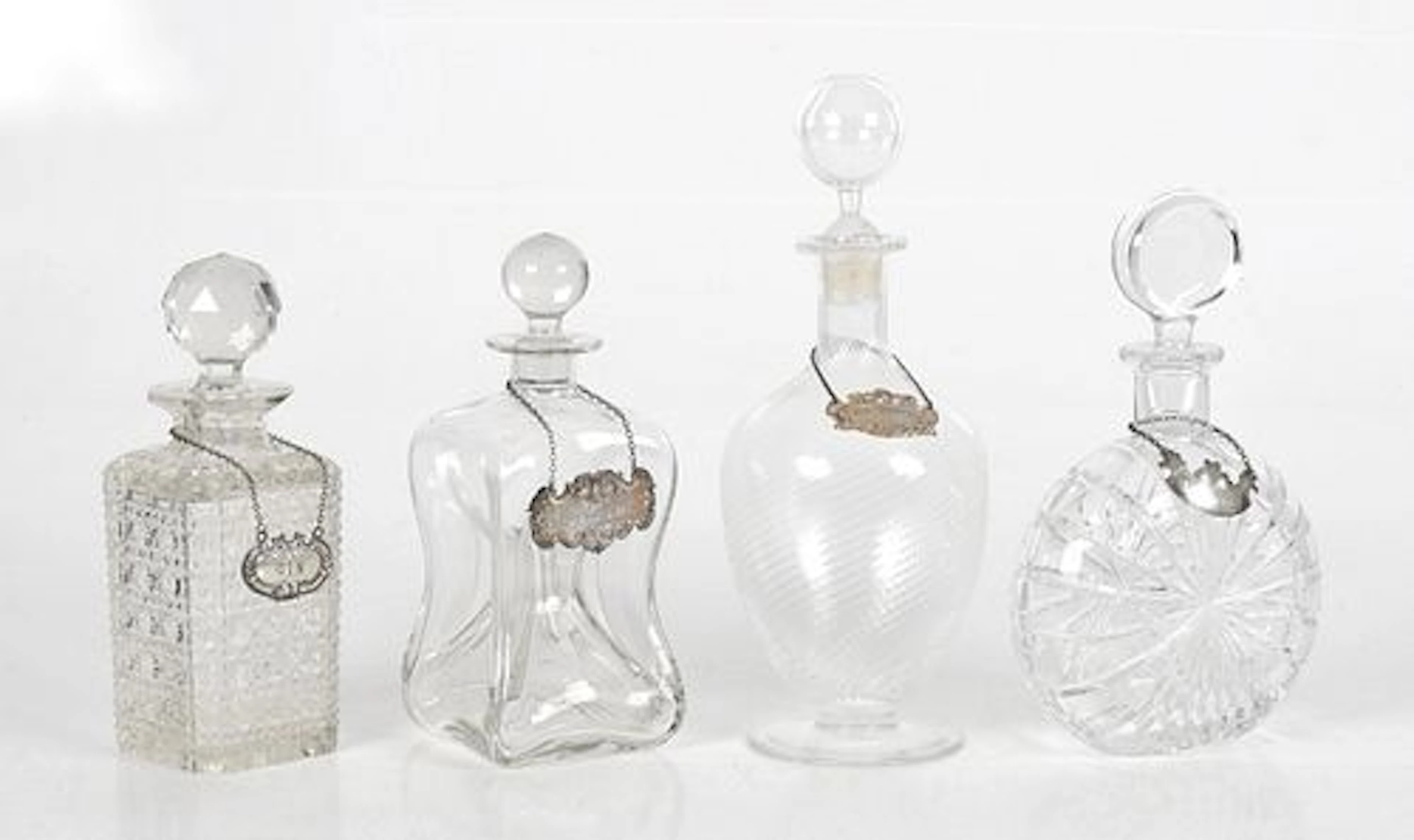 Four Glass Decanters and Labels