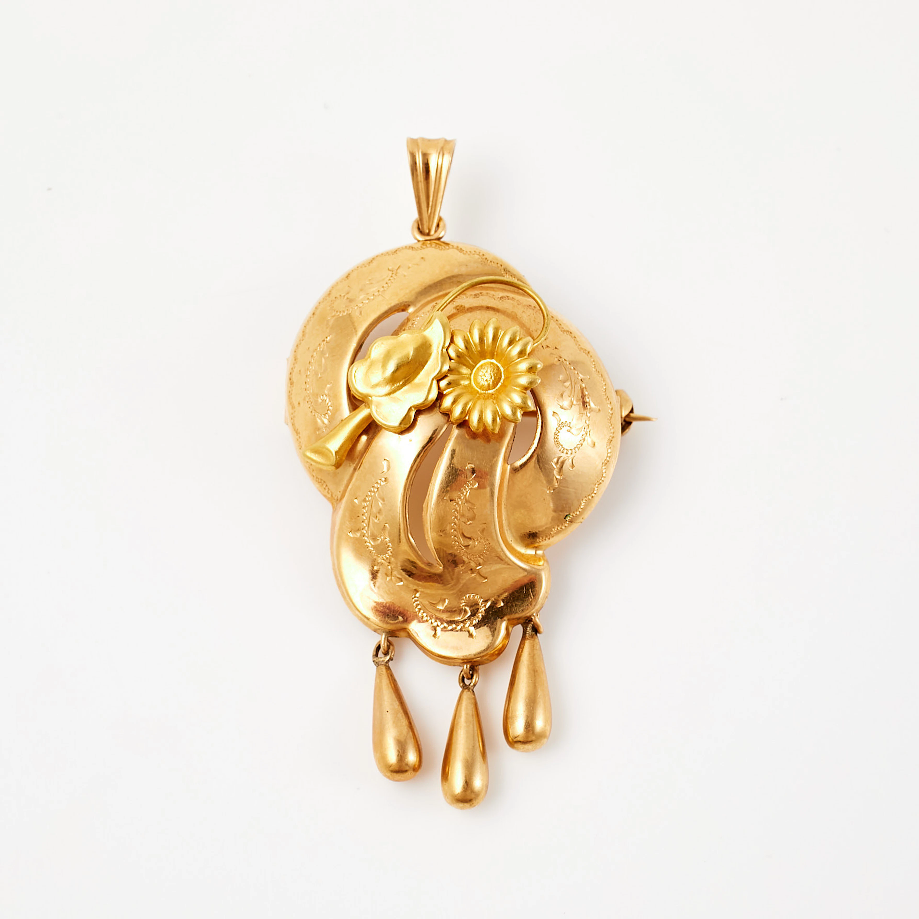 BROSCH, 18 k guld, med dekor av stiliserad blomma, behängd med tre