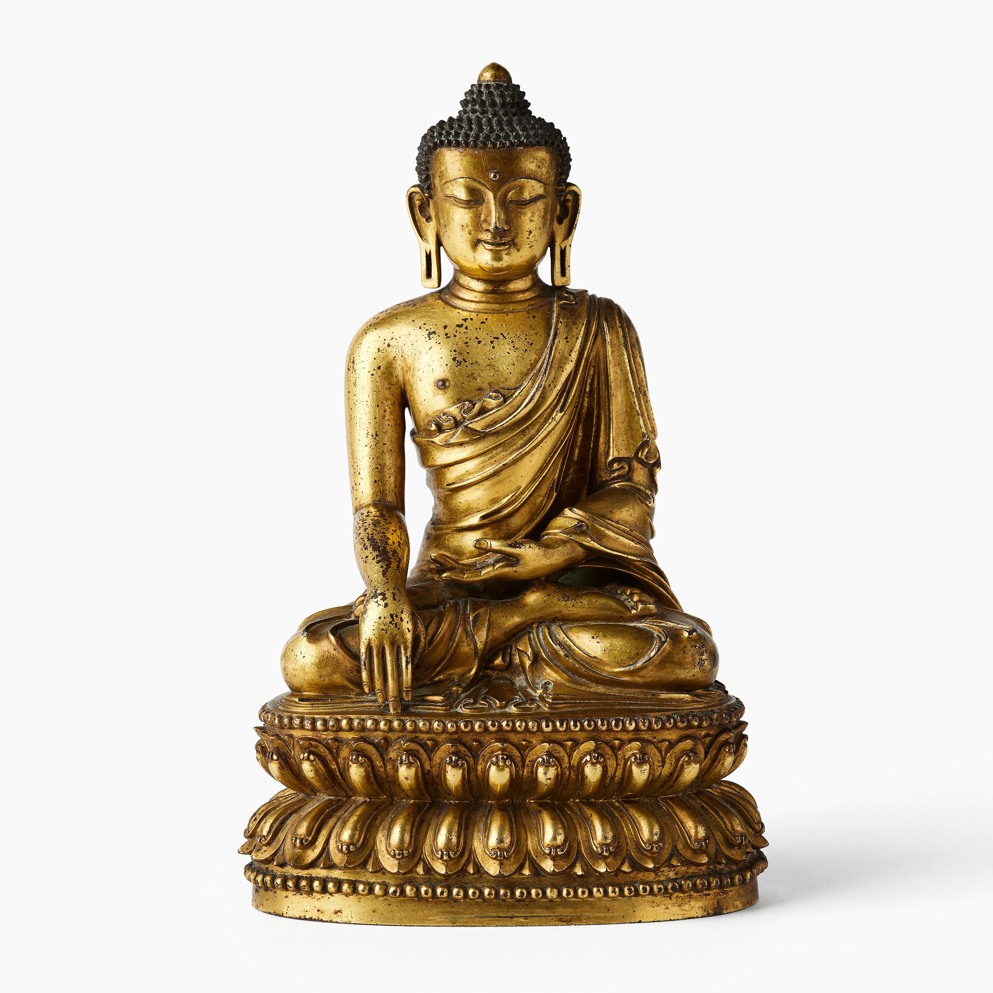 An Important Chinese Gilt-Bronze Figure of Shakyamuni Buddha.