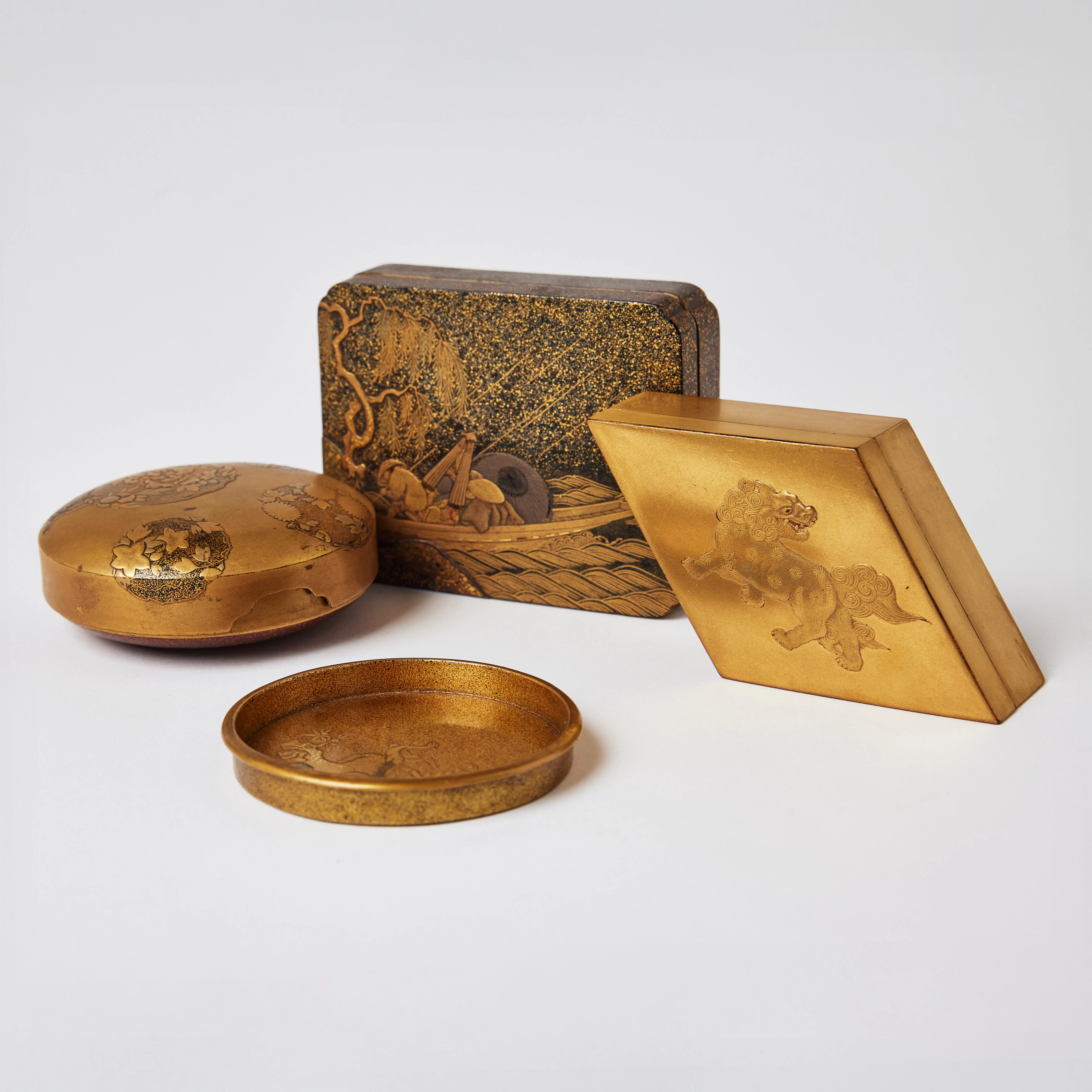 Three Japanese Gilt-Lacquer Boxes and Covers and a Small Dish.
