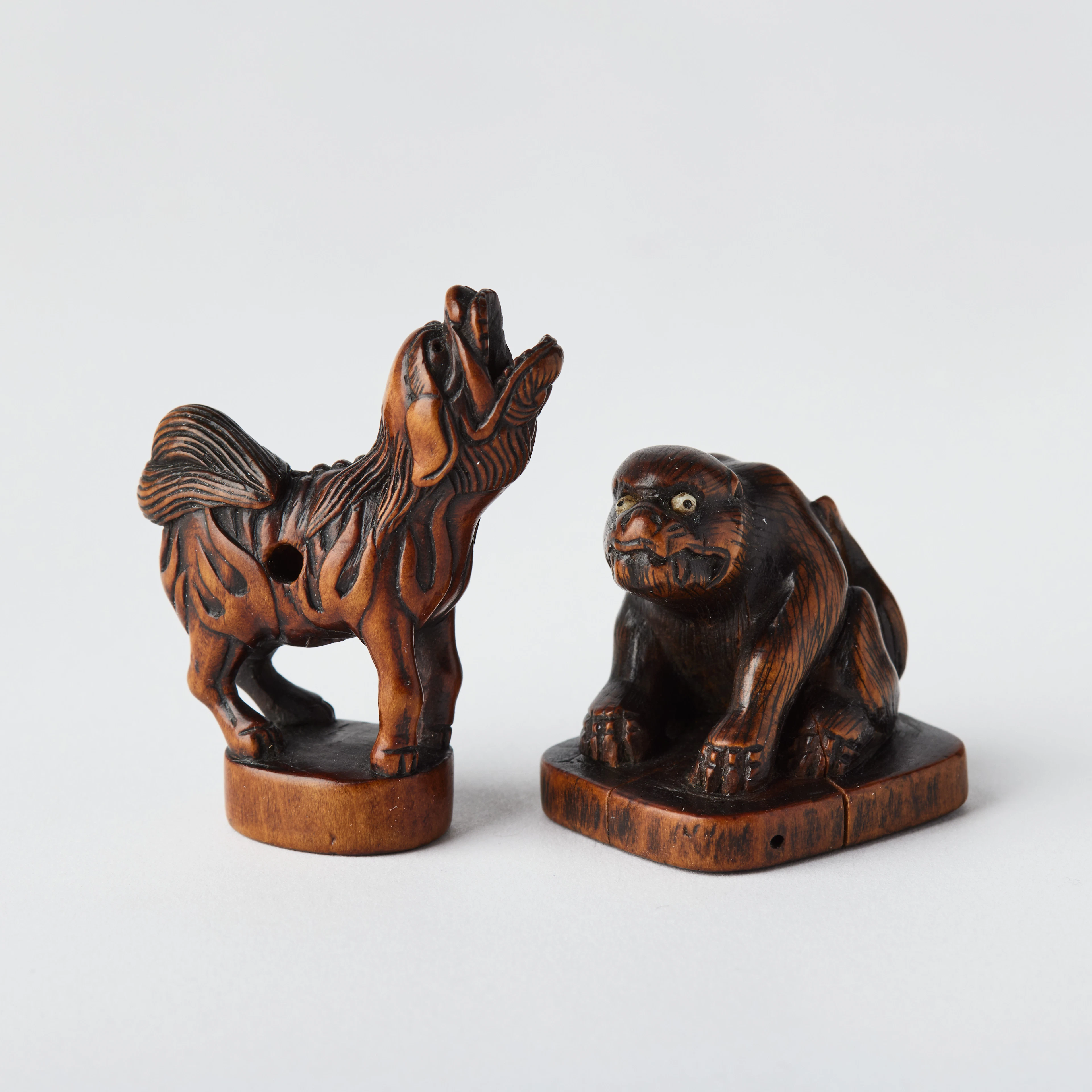 Two Japanese Wood Netsuke of Shishi.