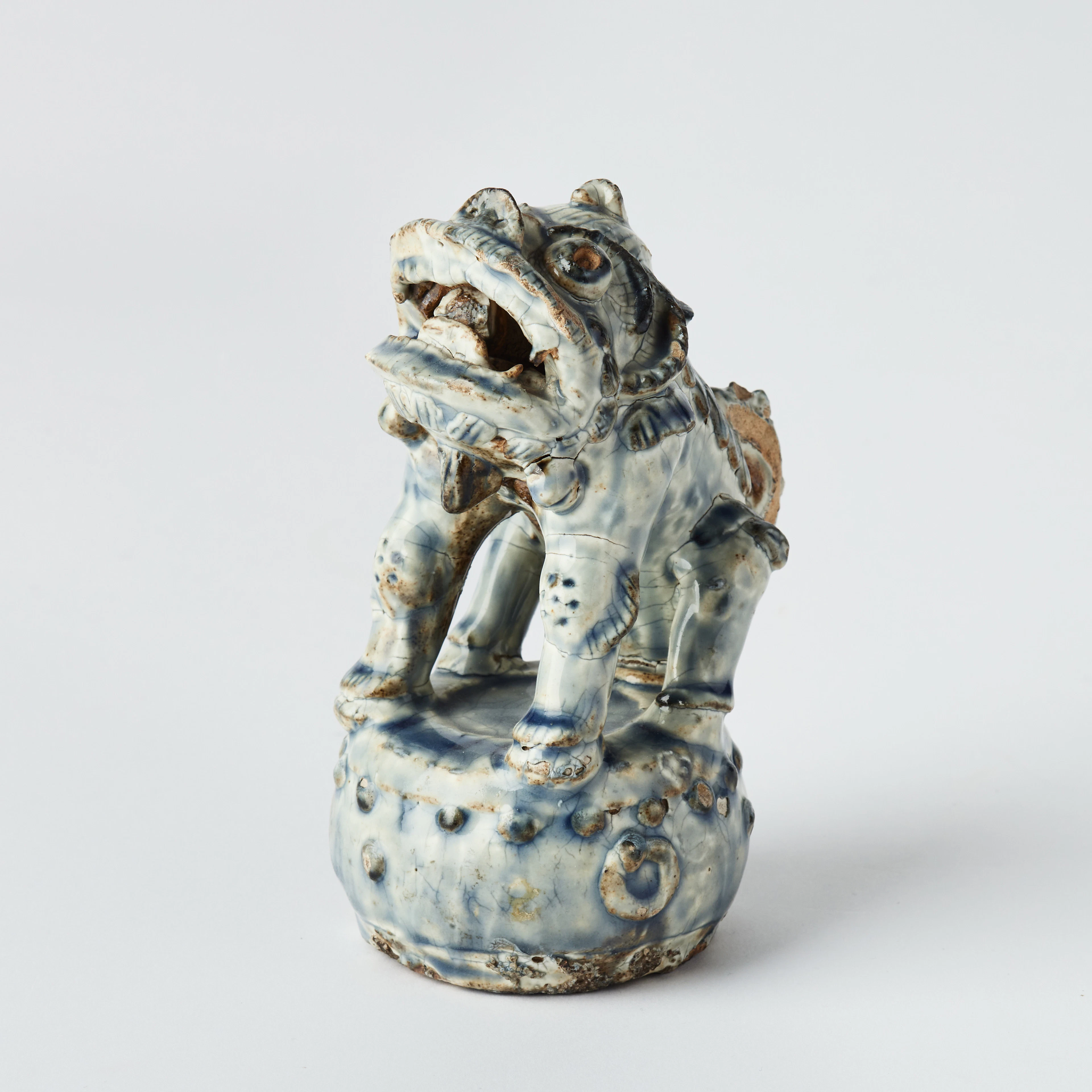 A Chinese Glazed Pottery Figure of a Buddhist Lion.