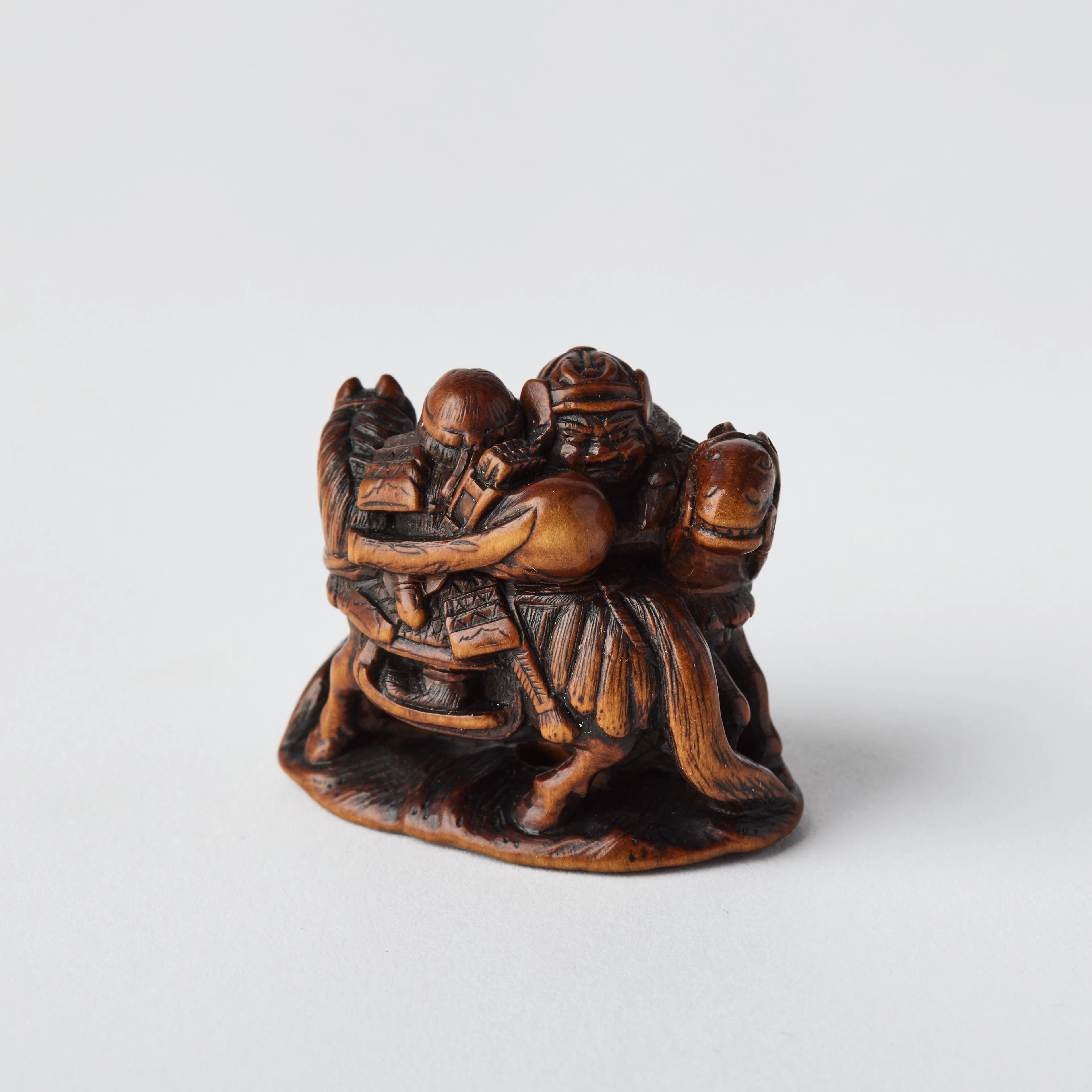 A Japanese Wood Netsuke of Two Samurai.