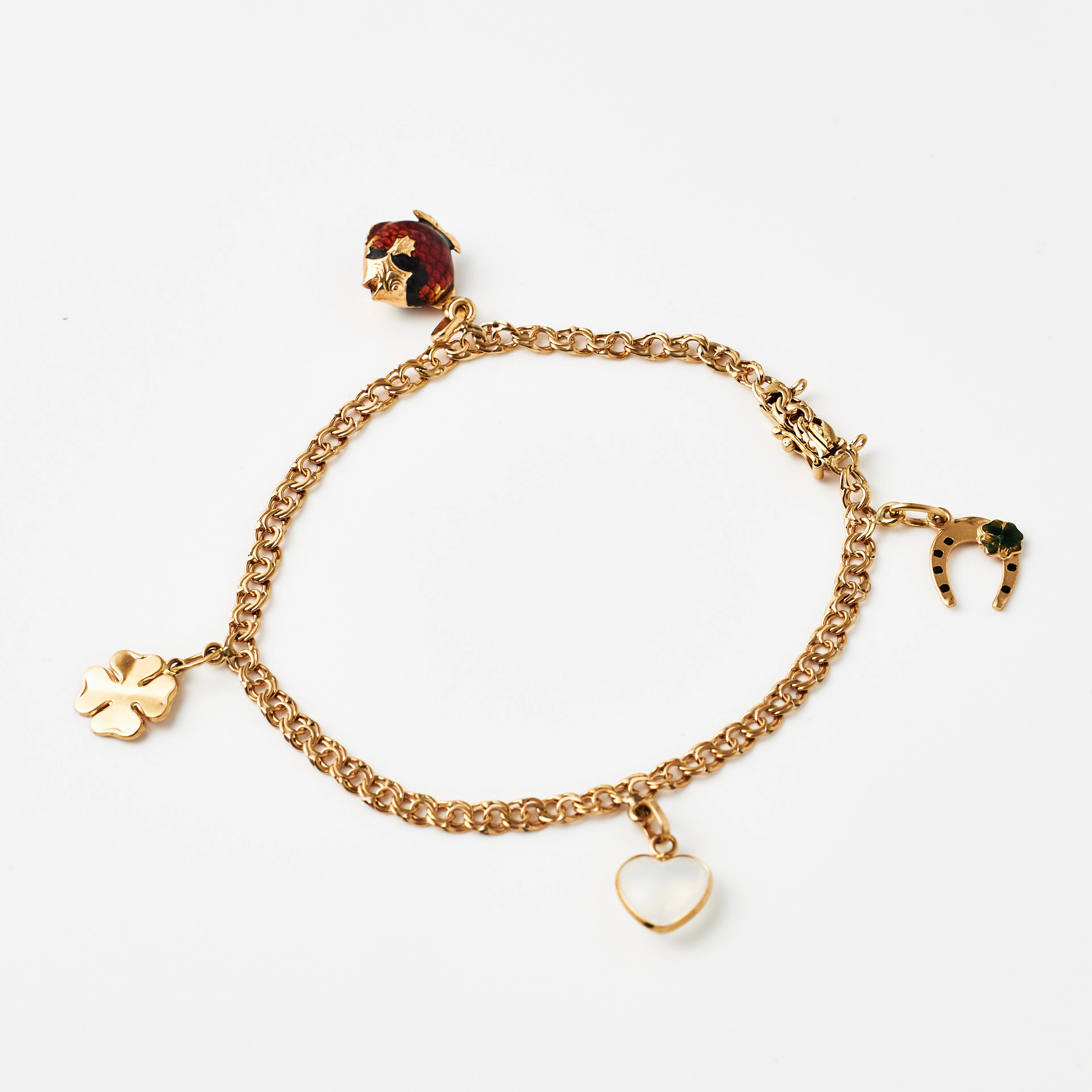 ARMBAND, 18 k guld, Bismarck, 4 berlocker bl a föreställande en hästsko