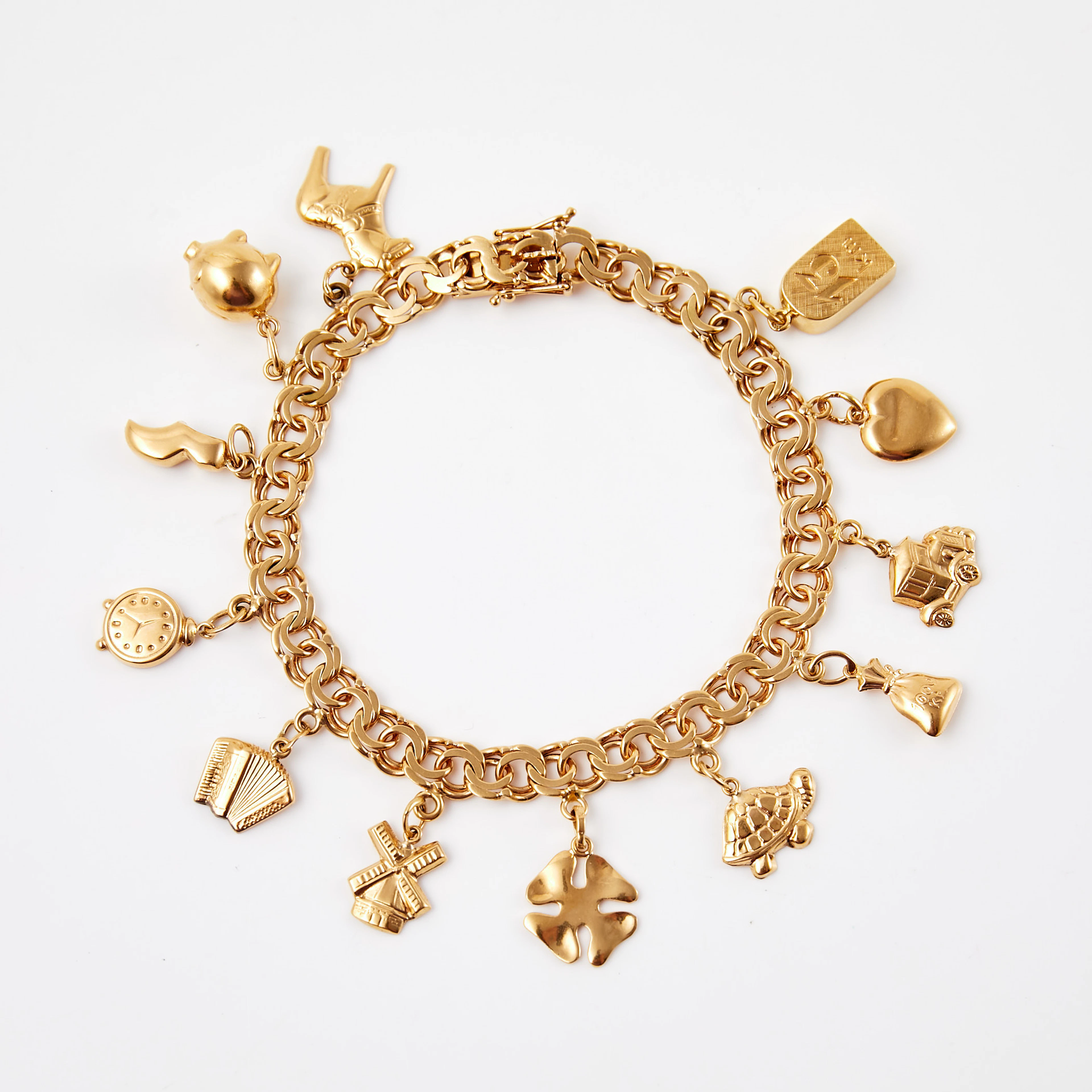 ARMBAND, 18 k guld, bismarck, berlocker i form av bl.a spargris, fyrklöver