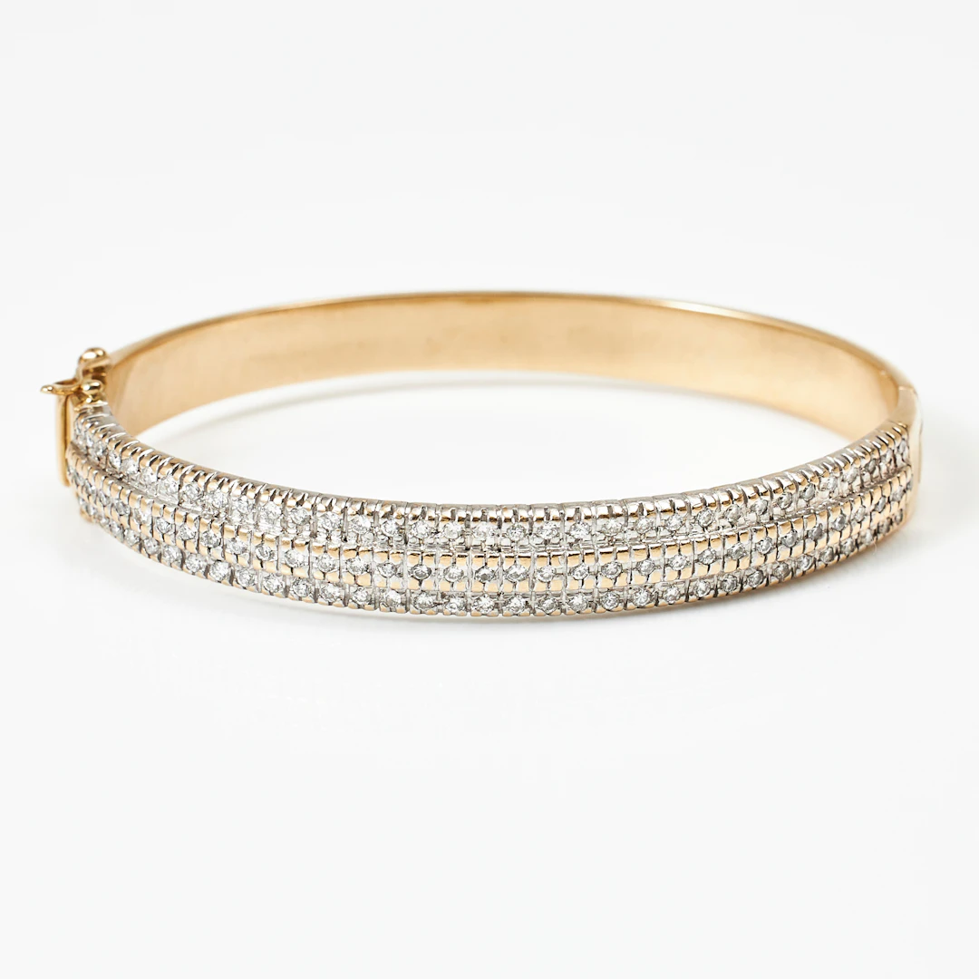 ARMRING, 14 k guld, en sida med dekor av 105 briljanter totalt ca