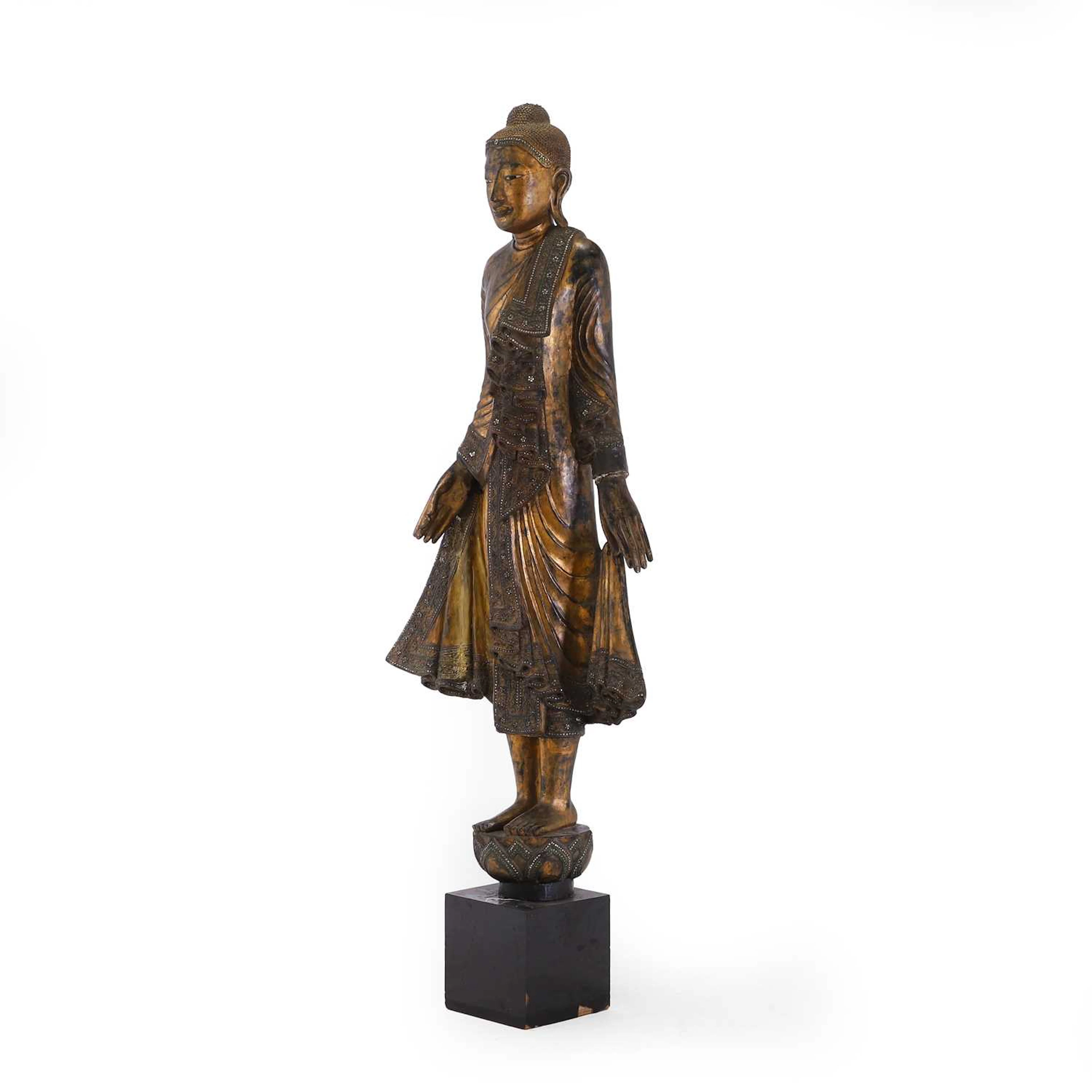 A large carved and lacquered standing Buddha Mandalay period (1853-1948)