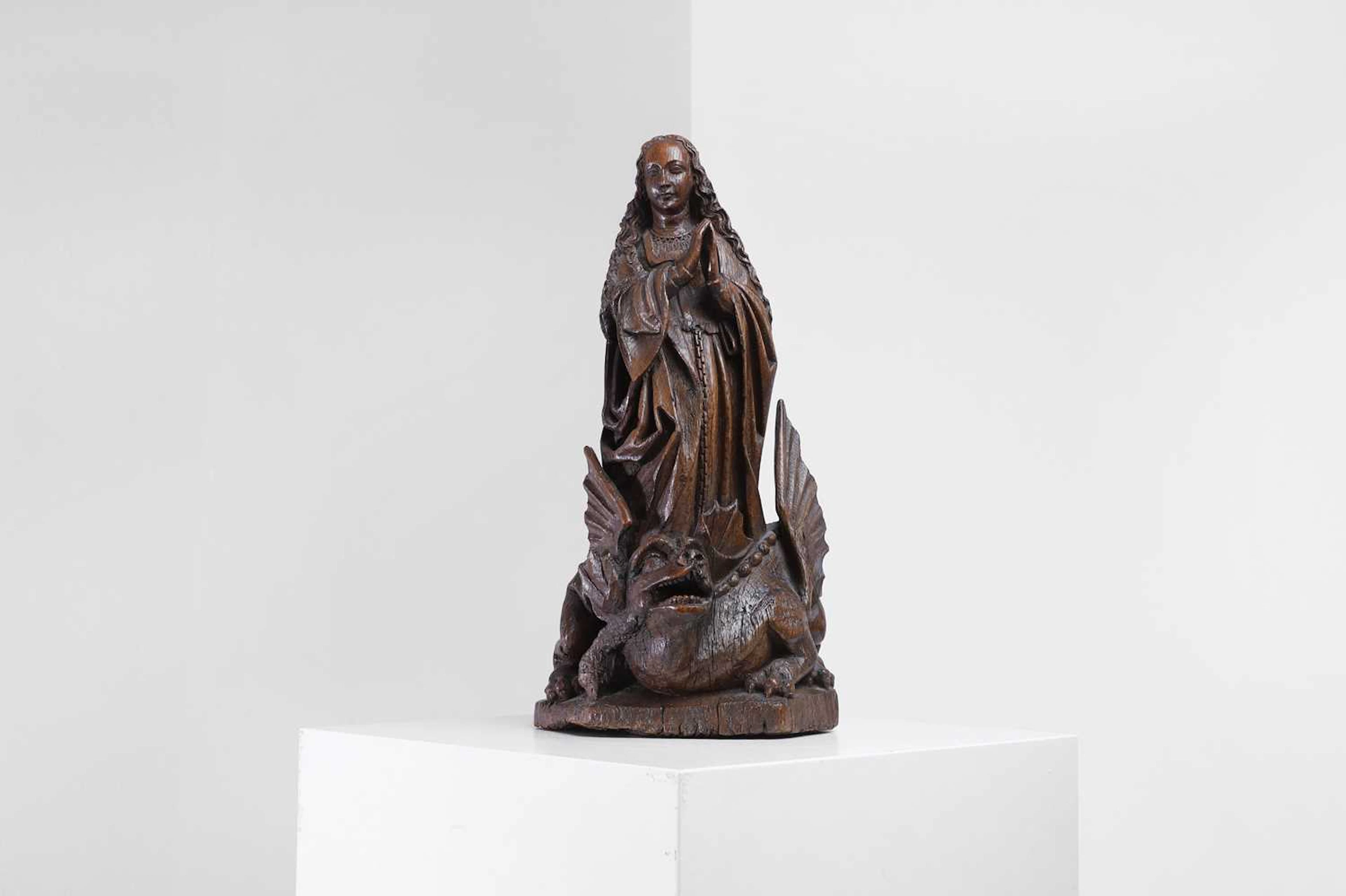 A carved oak figure of Saint Margaret of Antioch