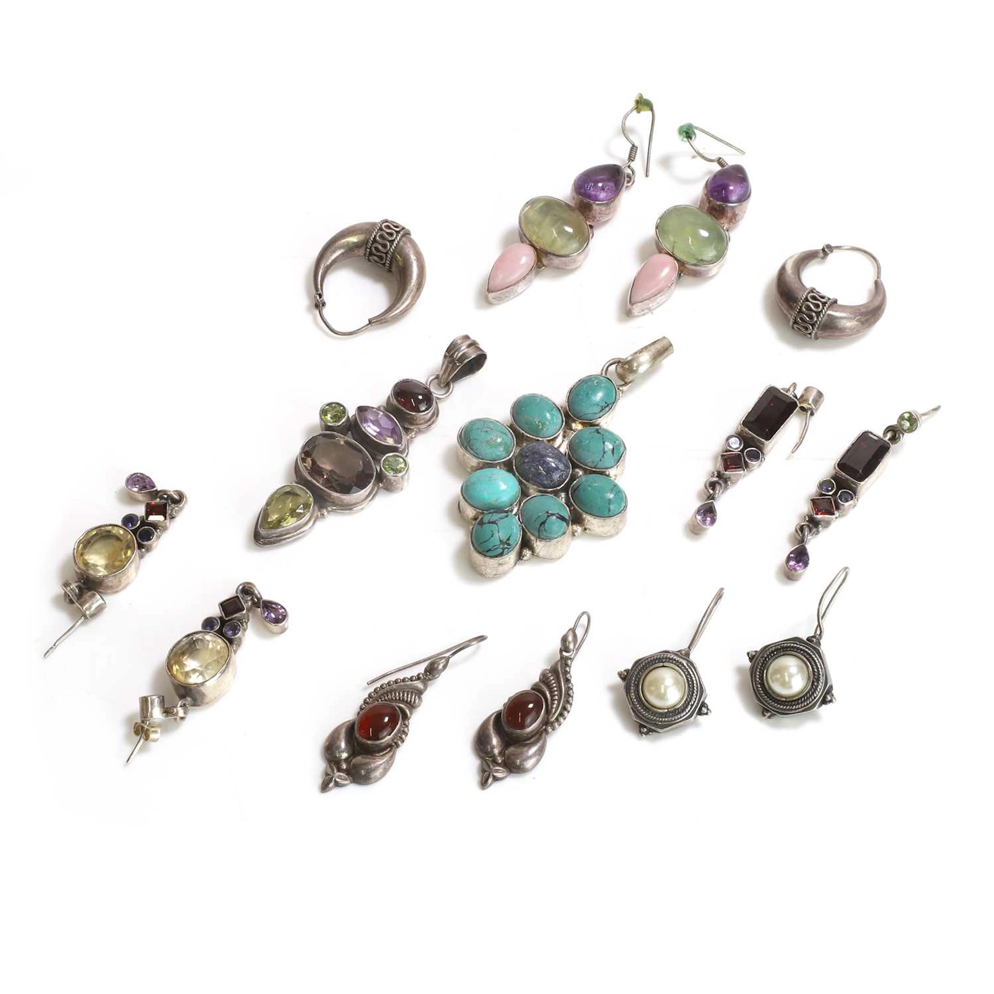 A group of silver multi-gem earrings and two pendants