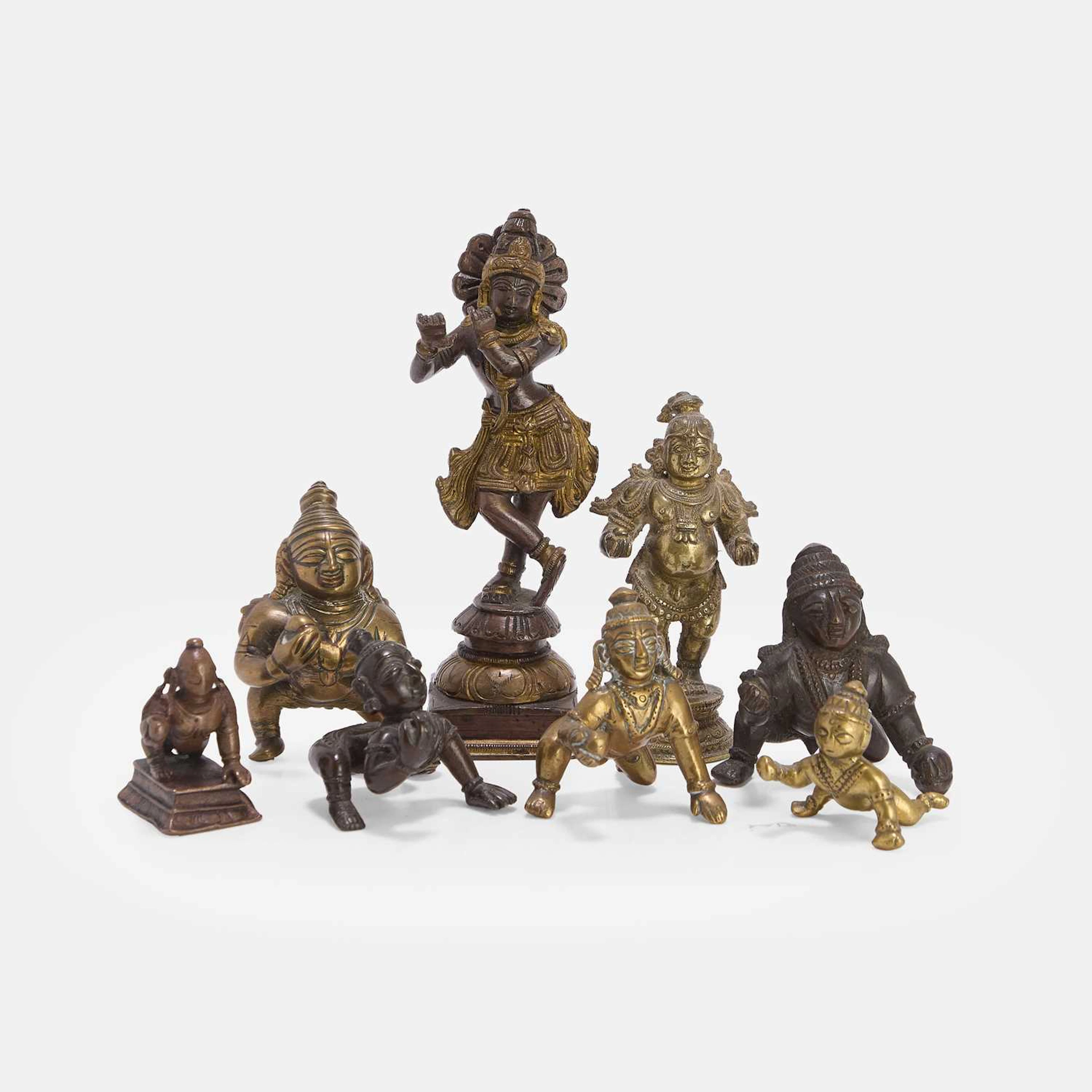 A collection of Indian brass Bala Krishna figures first half of the