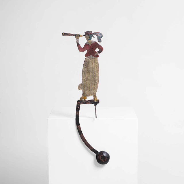 A metal folk art counterbalance toy