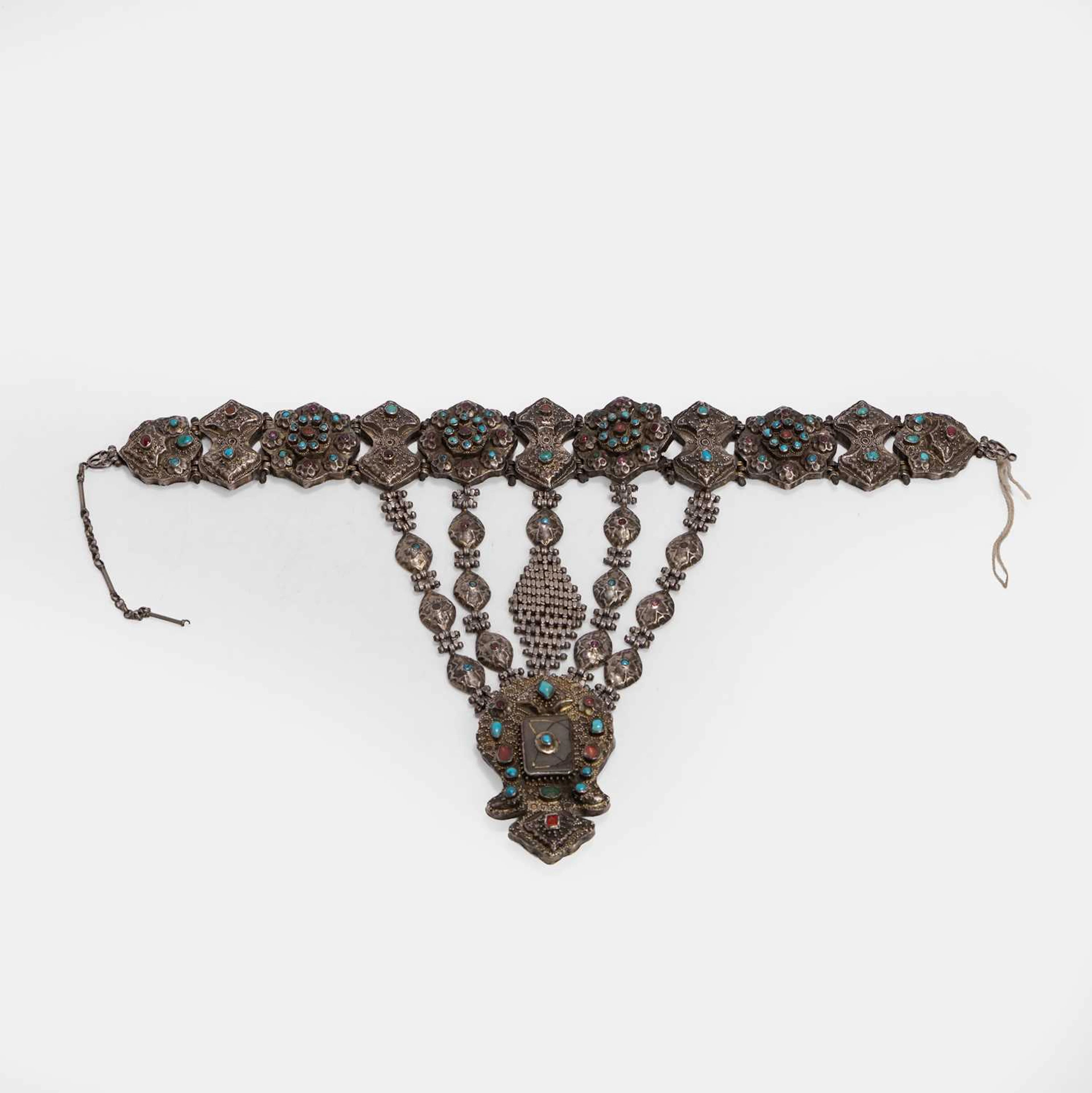 A gem-set and chased gilt white-metal pectoral ornament 19th century