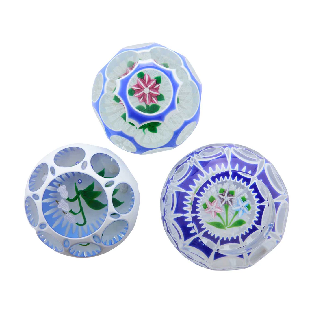 A group of three John Deacons cased glass paperweights 1996 and 2001