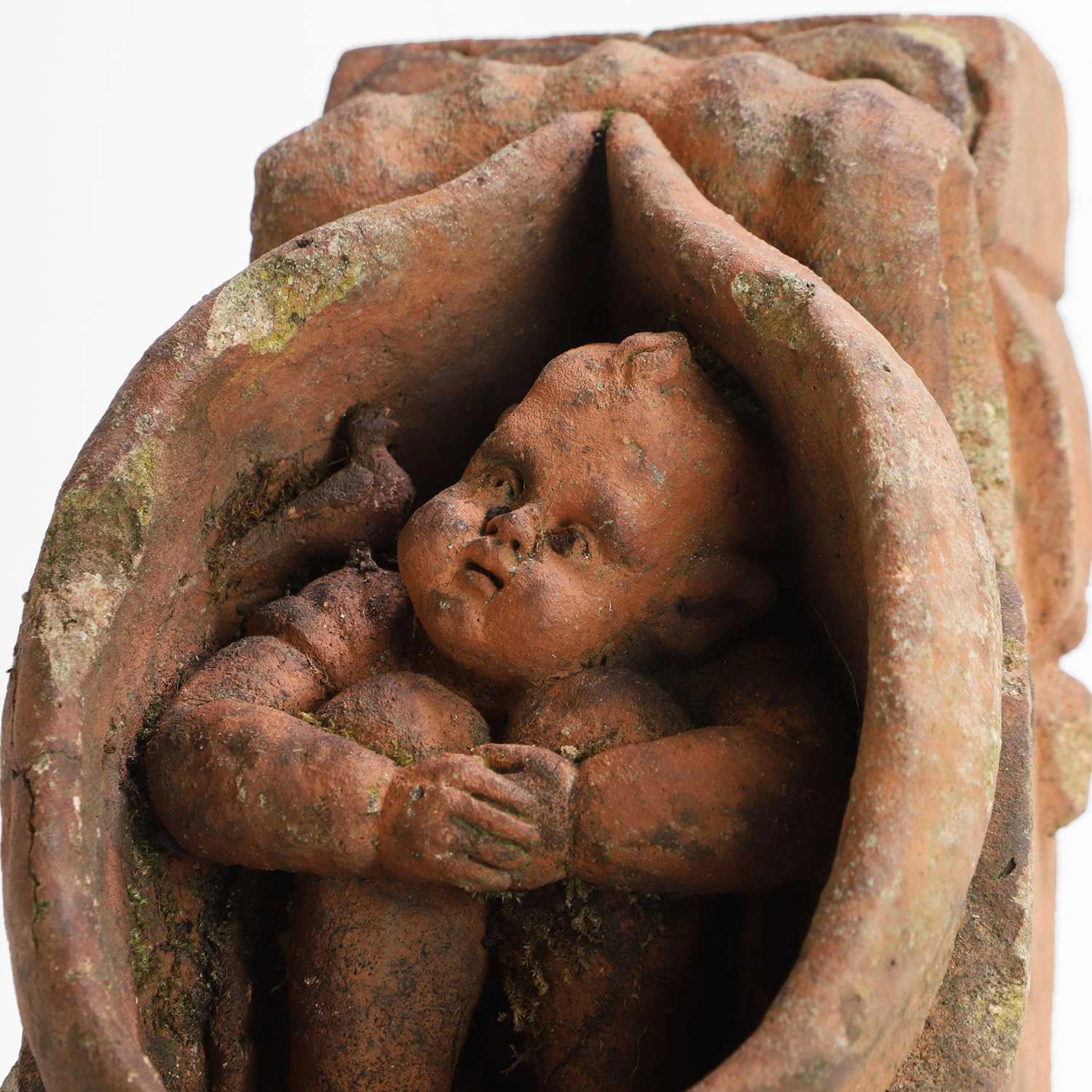 A terracotta gargoyle attributed to Compton Pottery