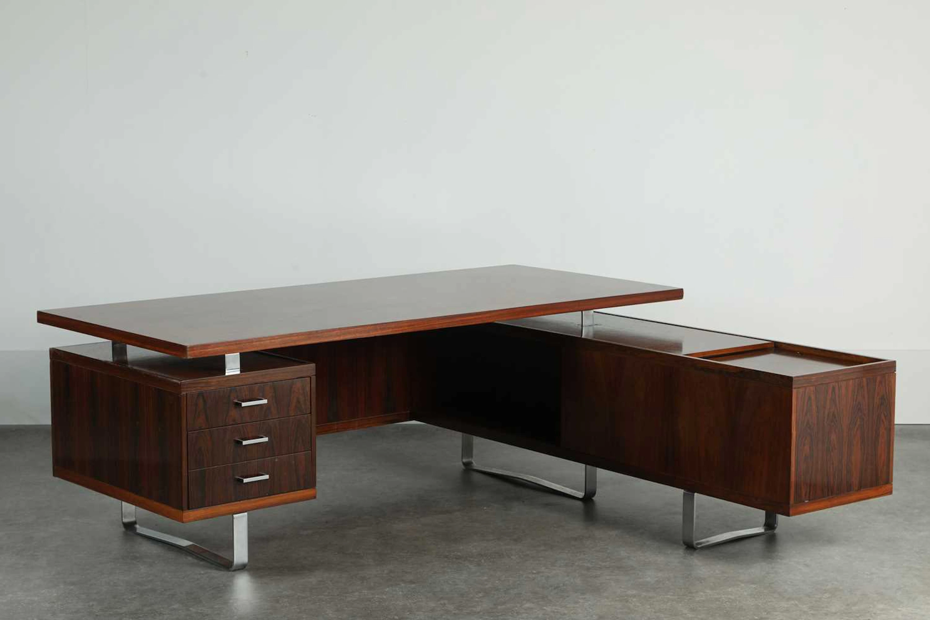 § A rosewood and steel executive desk