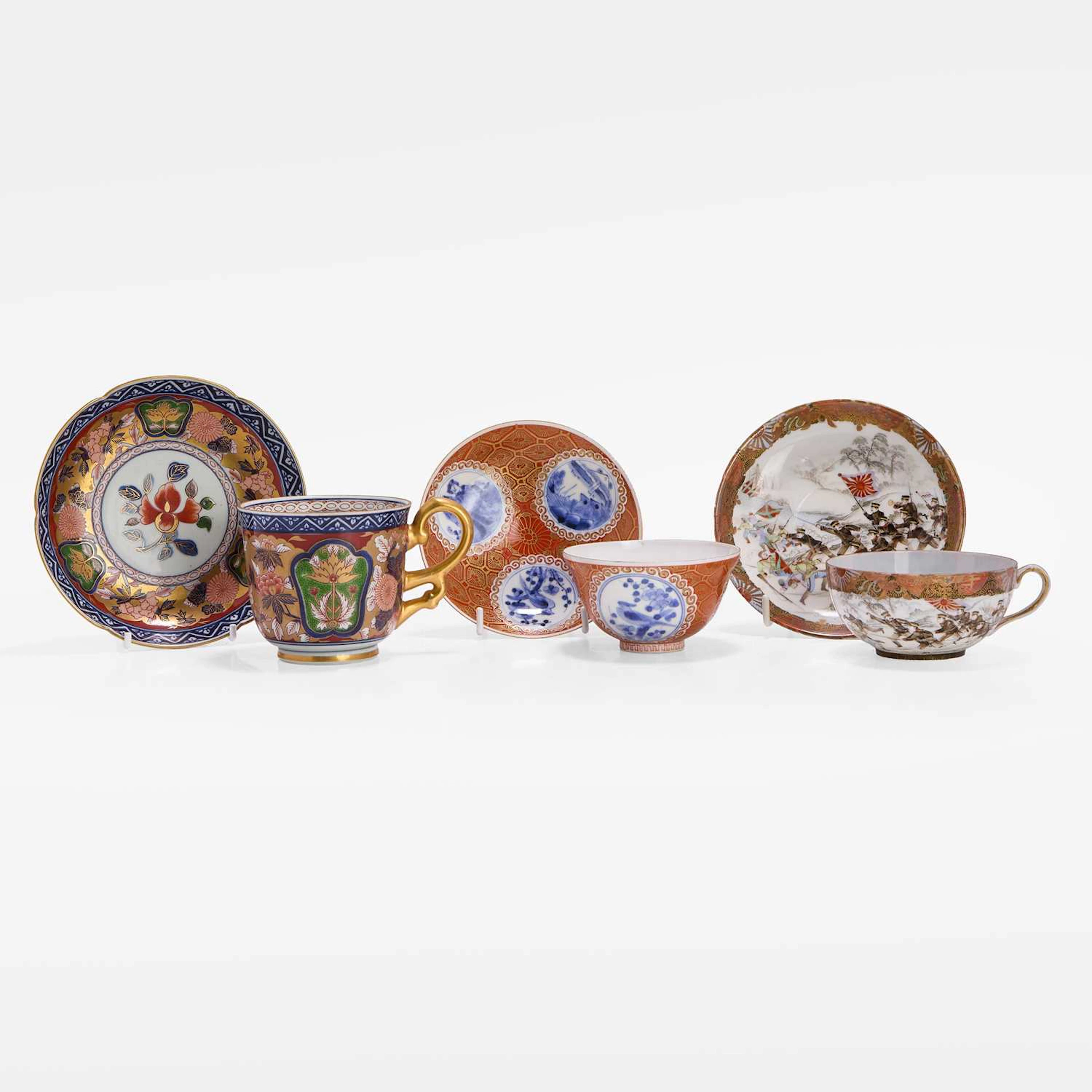A group of three Japanese porcelain cups and saucers 19th-20th century