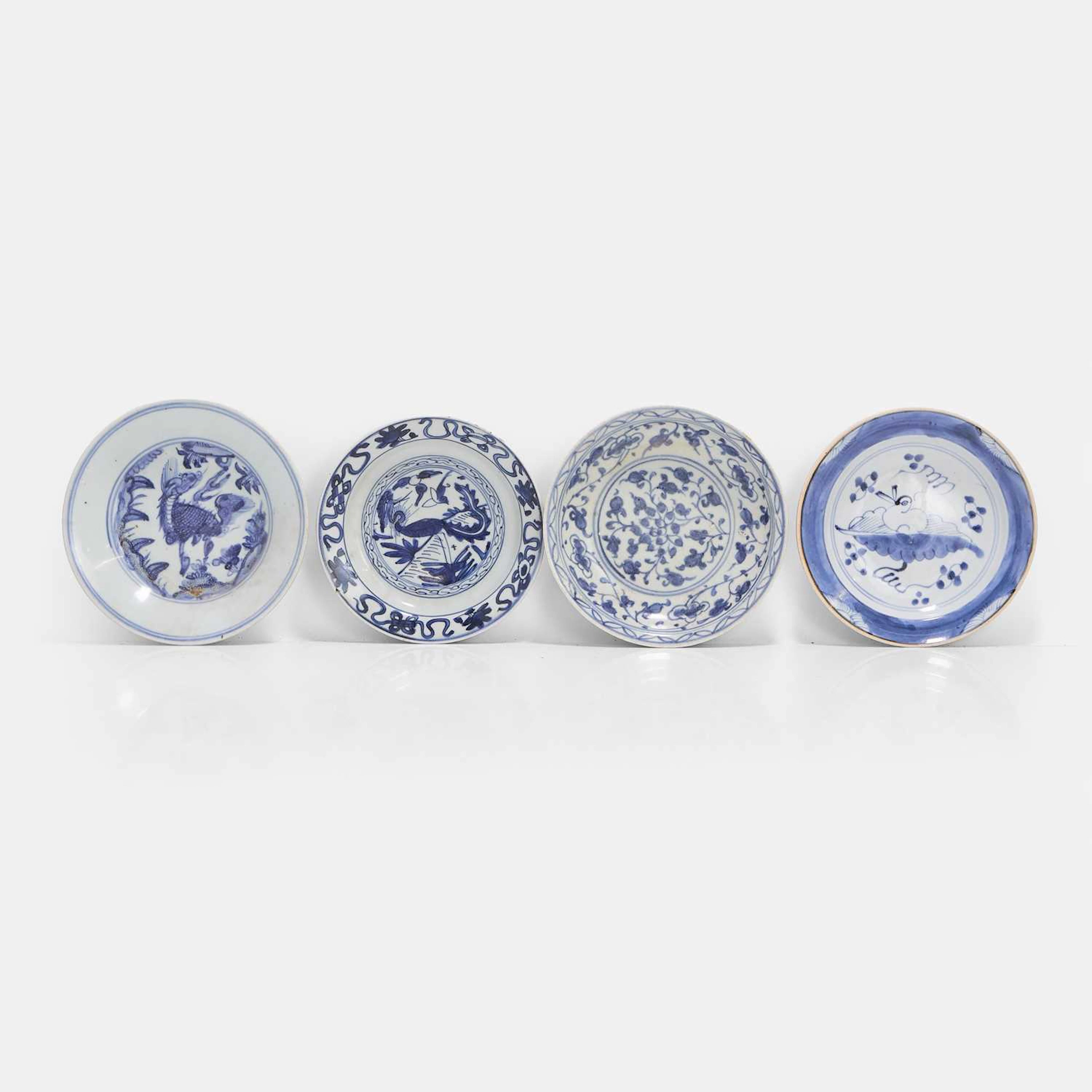 A group of four Chinese blue and white plates late Ming dynasty