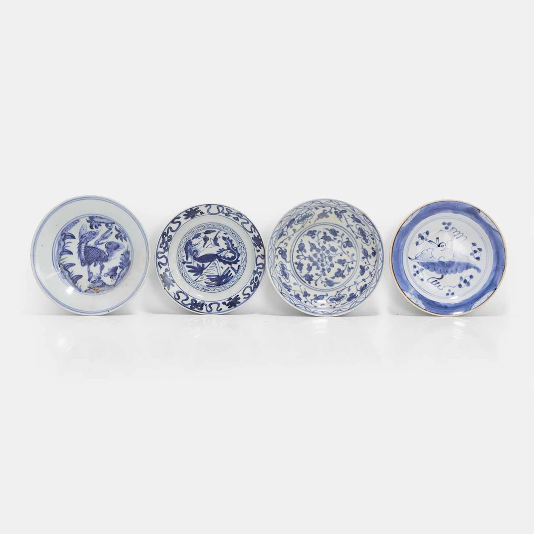 A group of four Chinese blue and white plates late Ming dynasty