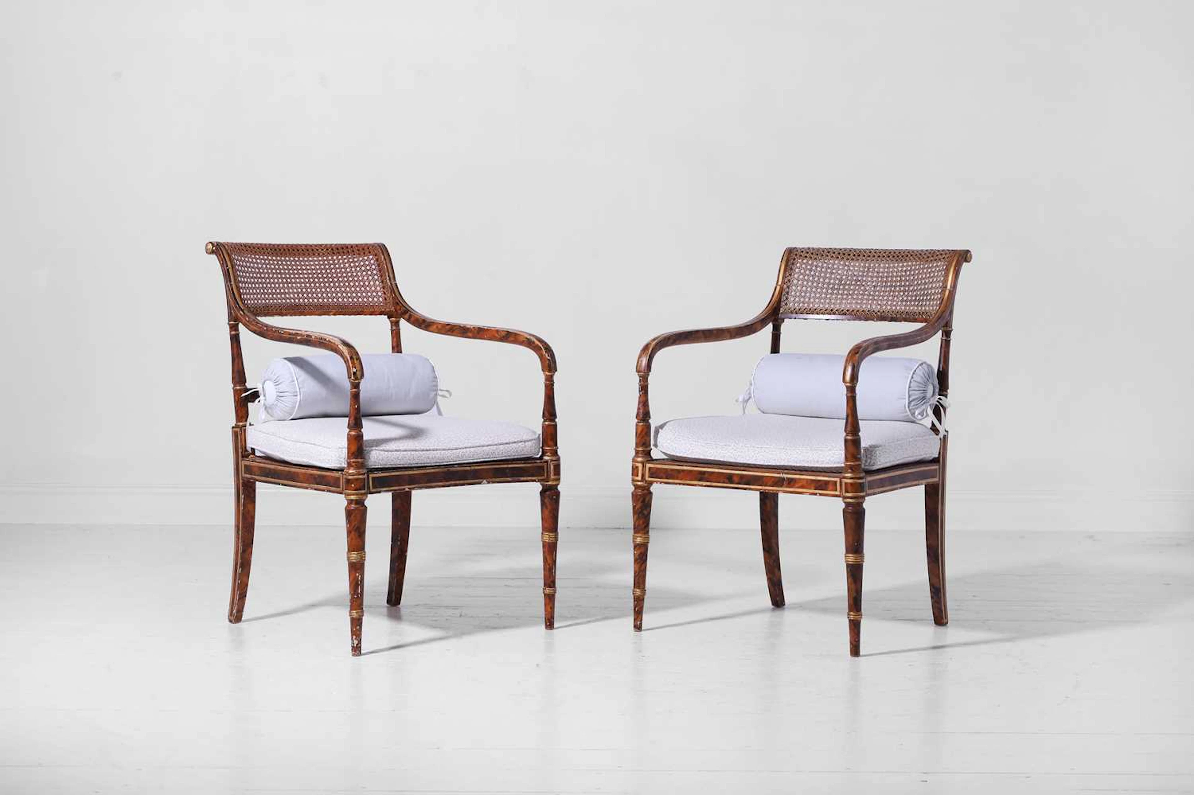 A pair of Regency-style painted and parcel-gilt beech elbow chairs