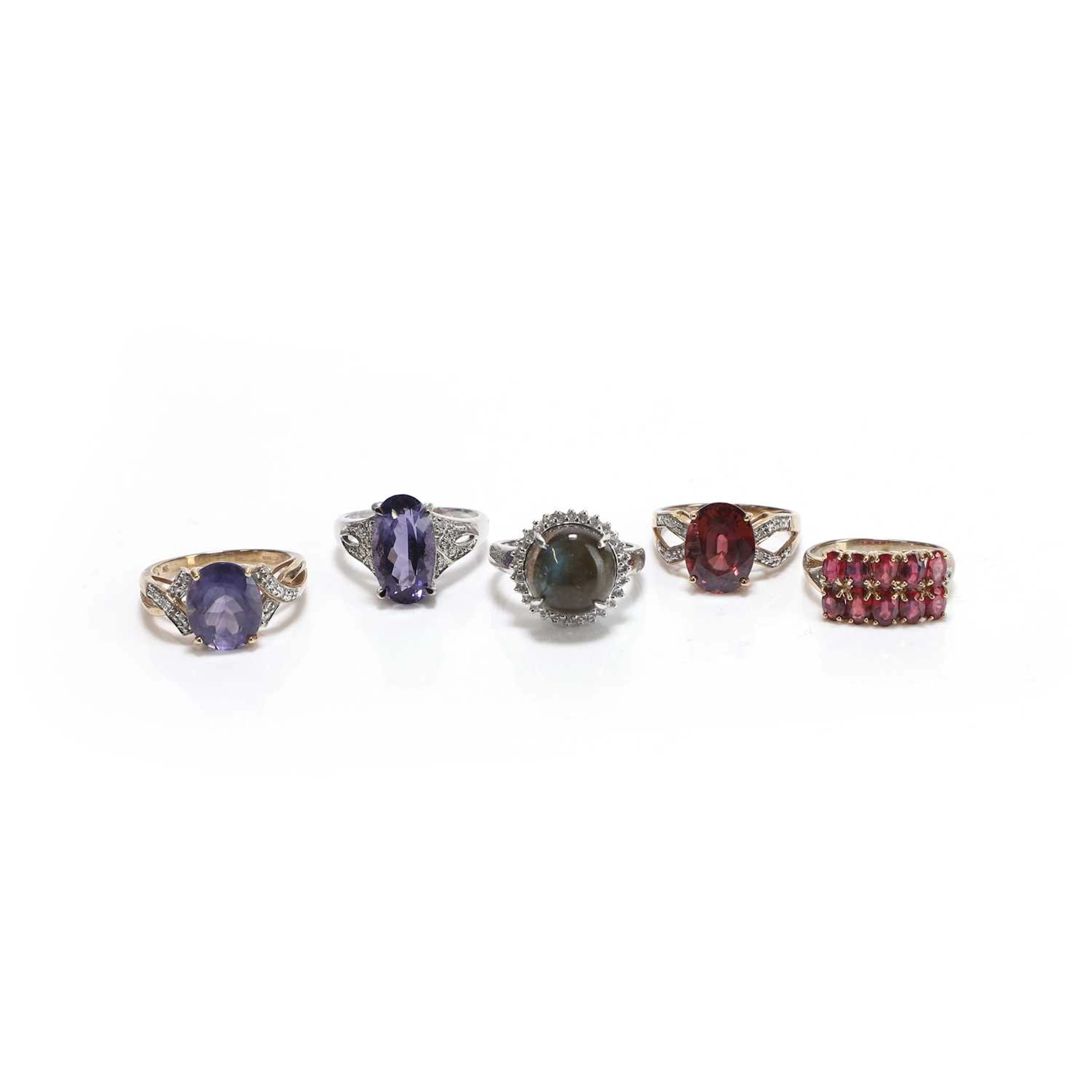 A group of five gold and silver gemstone set rings