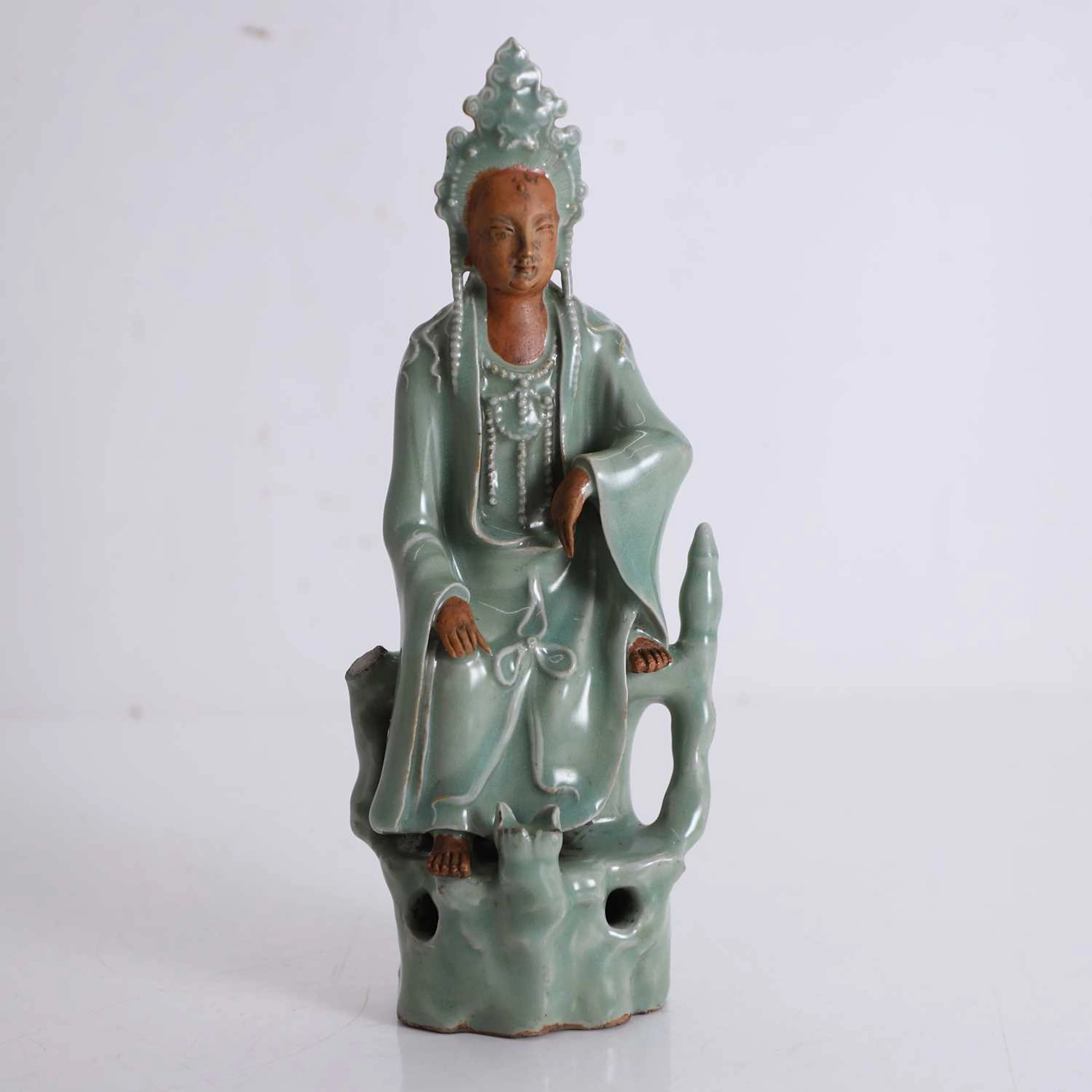 A celadon glazed figure of Guanyin