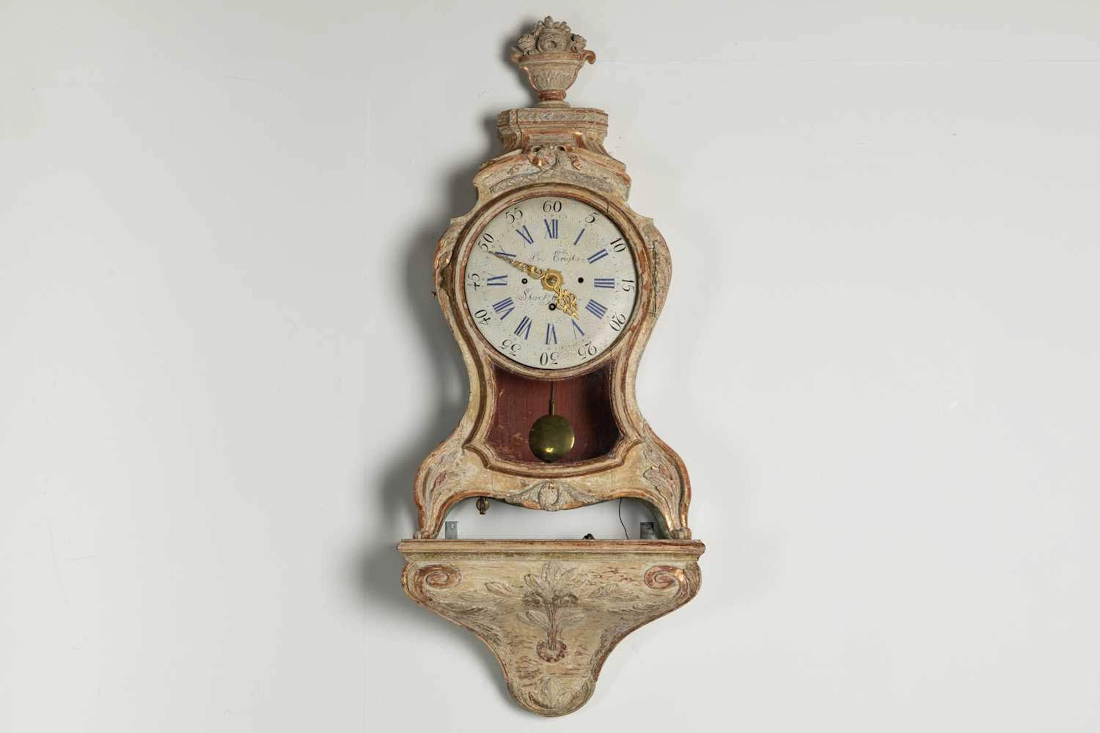A rococo cartel clock with bracket