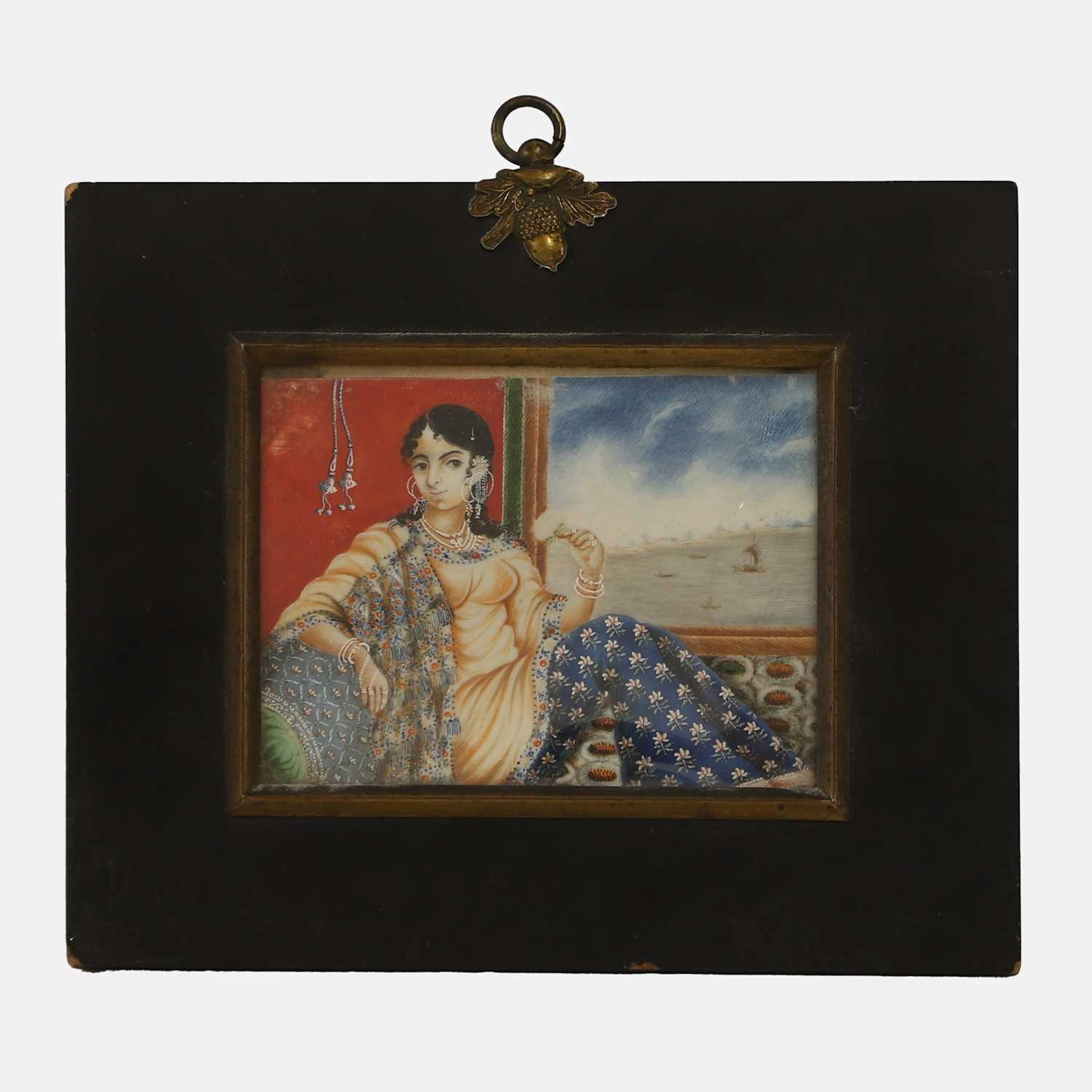 An Indian ivory portrait miniature of a reclining courtly lady circa