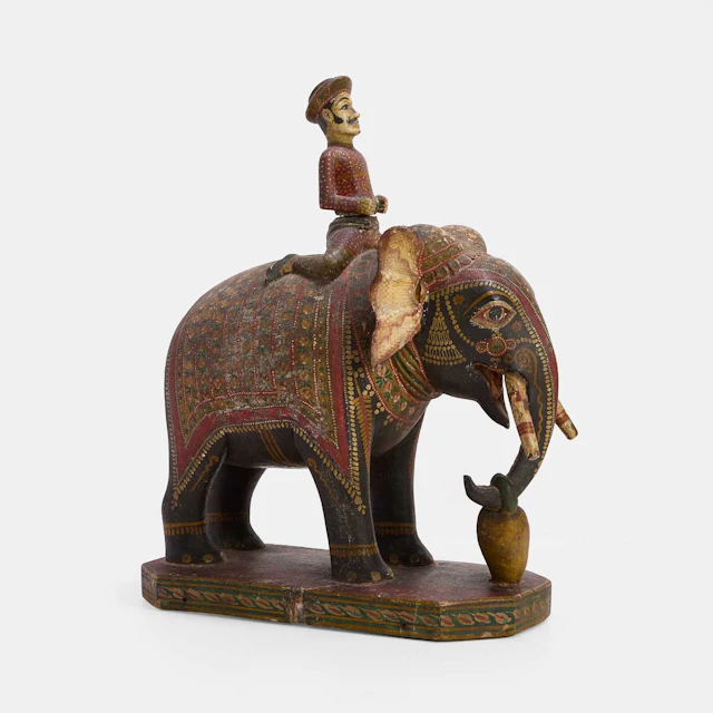 An Indian carved and polychrome painted wooden elephant late 19th/early