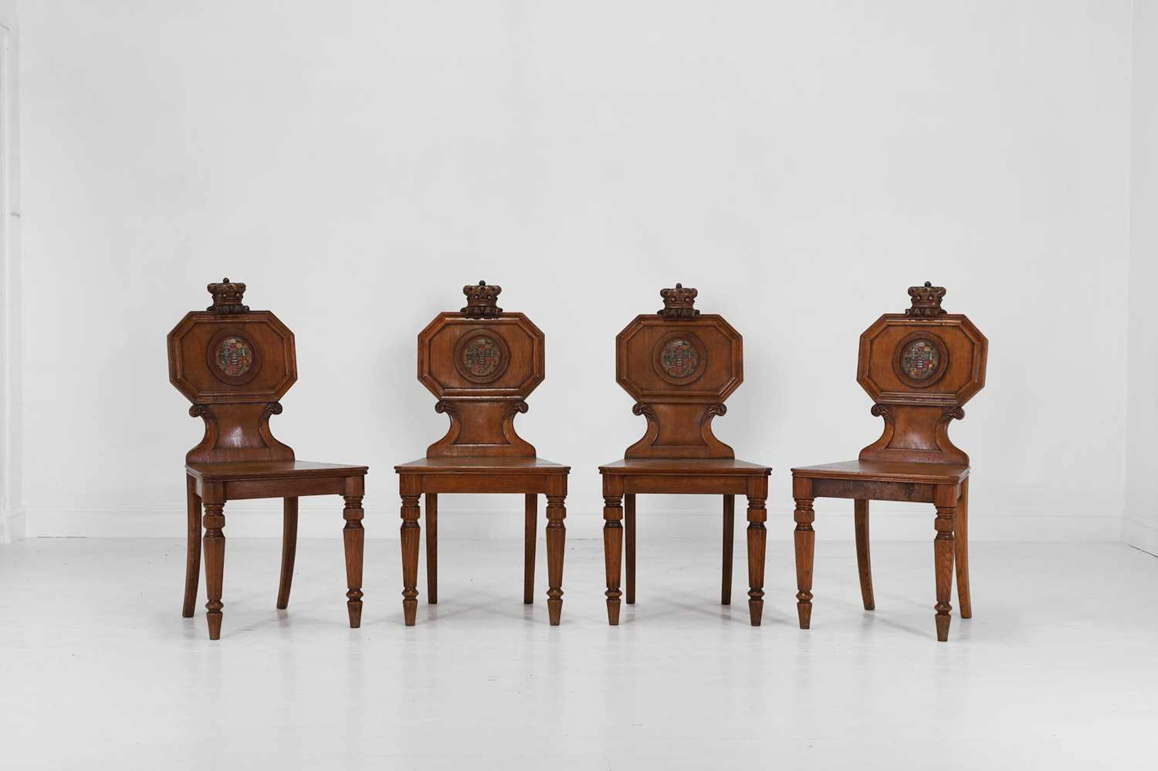 A set of four William IV golden oak ducal hall chairs