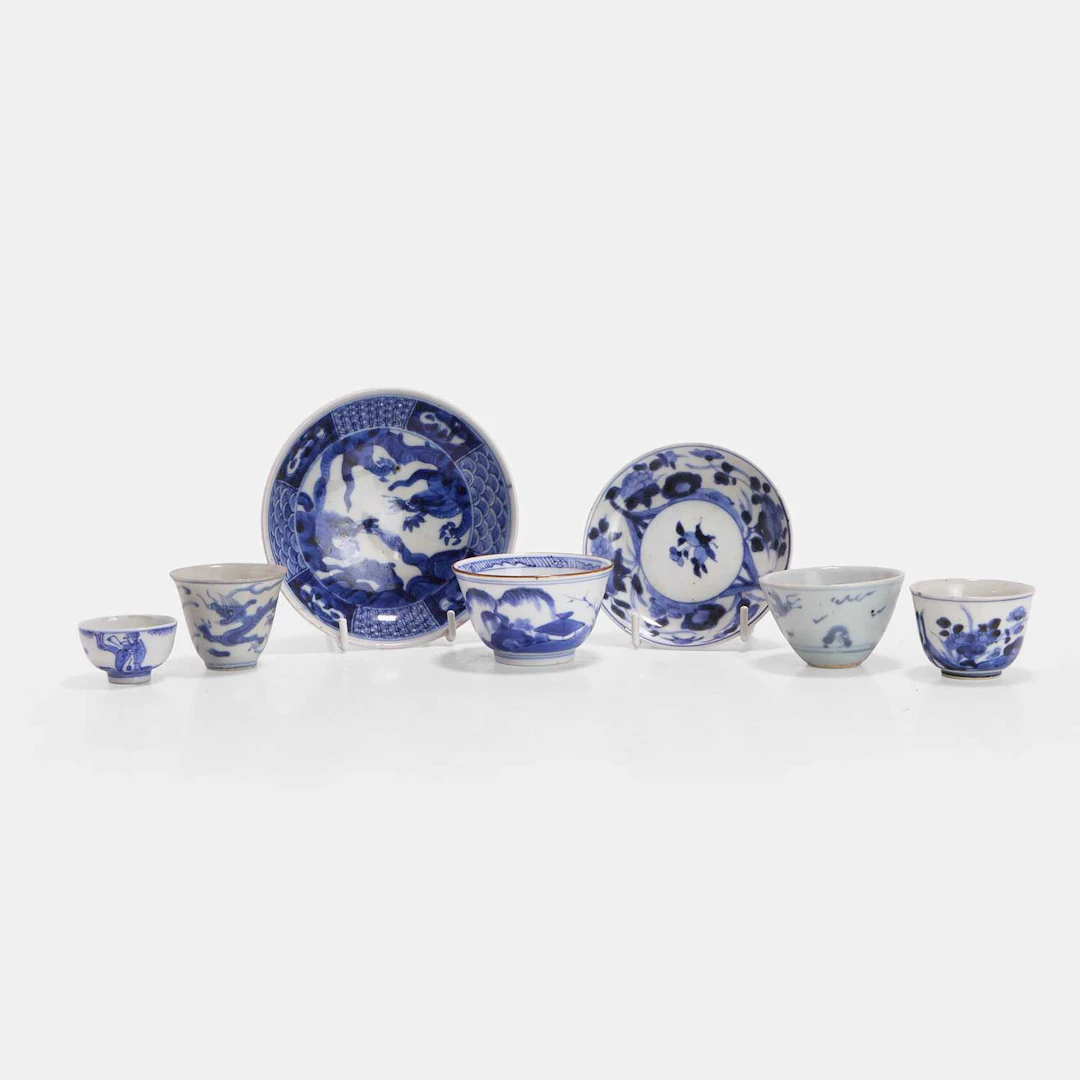 A collection of Chinese and Japanese blue and white cups and saucers