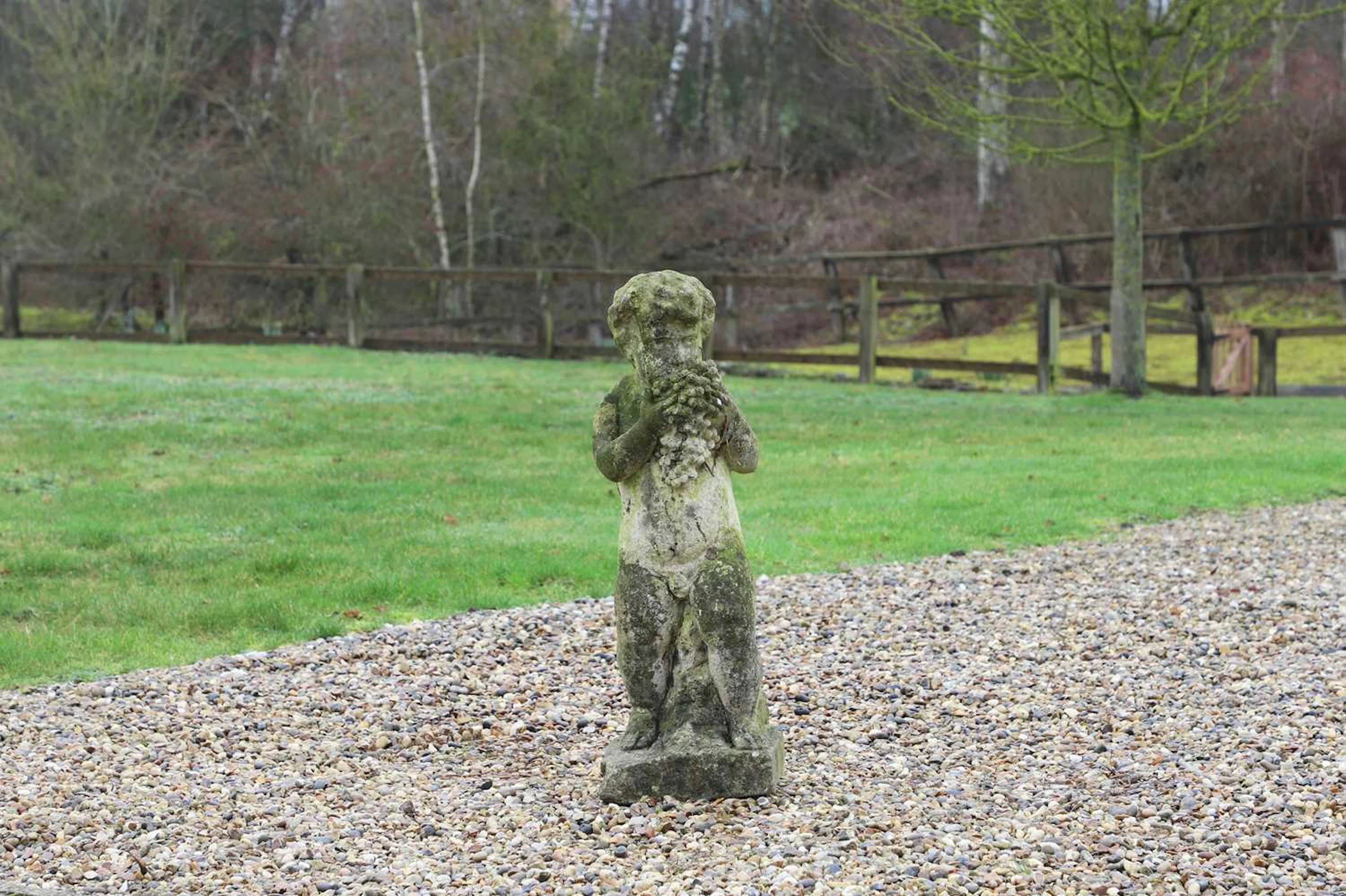 A reconstituted stone putto 20th century