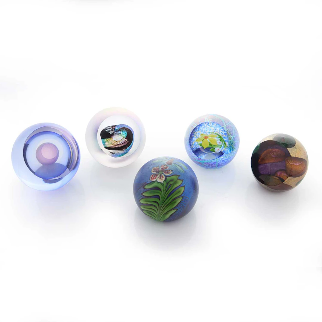 A group of five glass paperweights late 20th century and later
